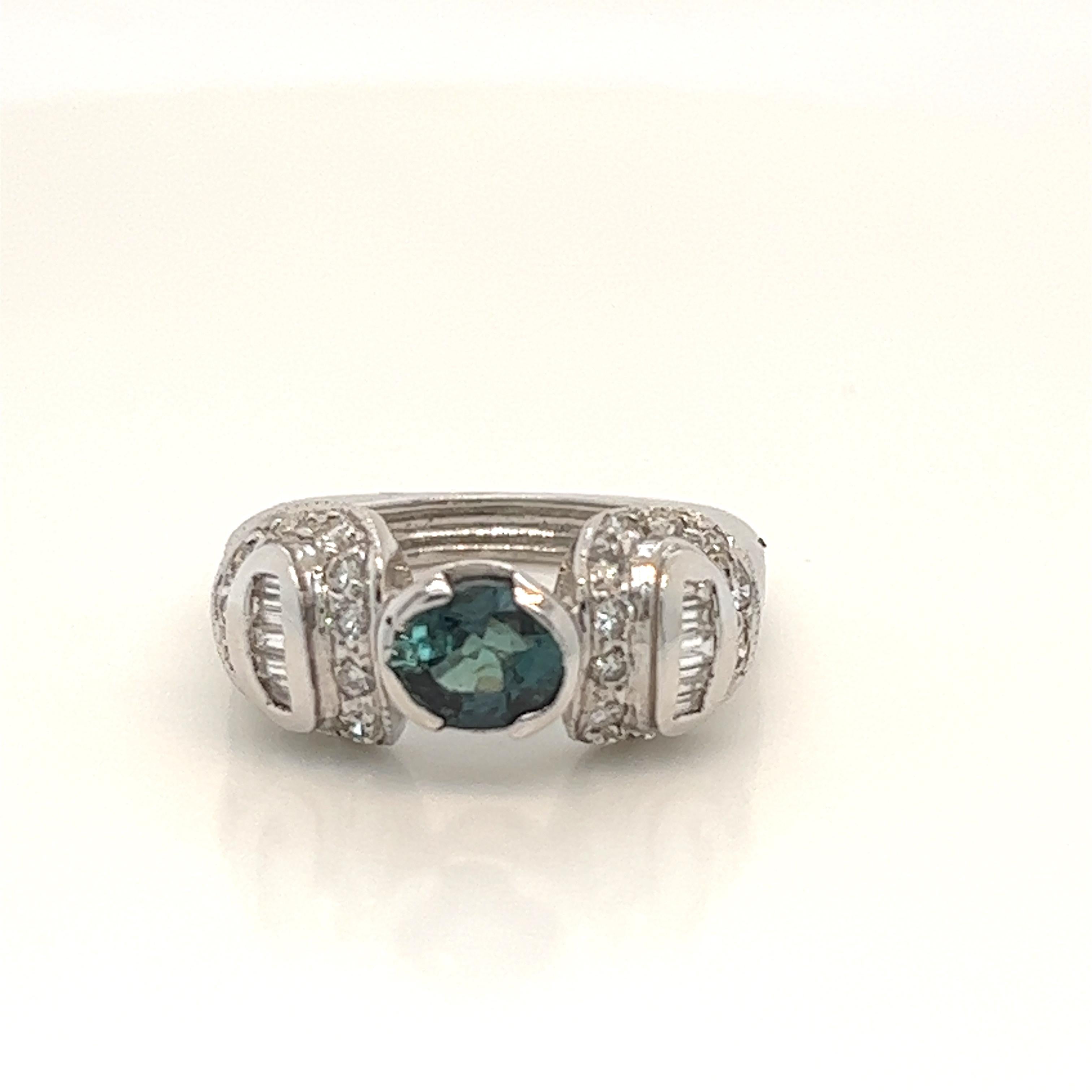 This is a gorgeous natural AAA quality Oval Alexandrite with Baguette diamonds that is set in solid 18K white gold. This ring features a natural 1.29 carat oval alexandrite that is certified by the Gemological Institute of America (GIA). The ring is