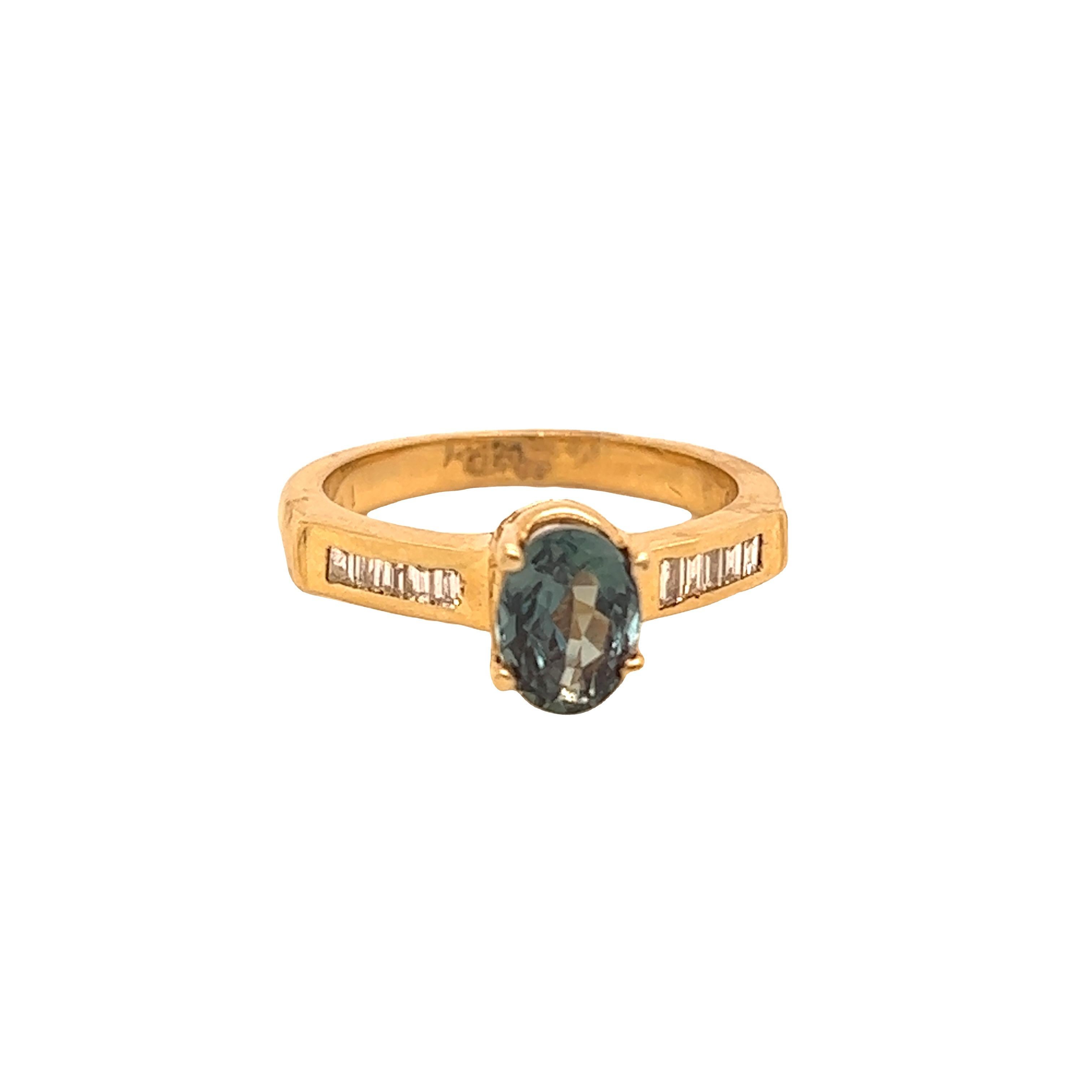 This is a gorgeous natural AAA quality Oval Alexandrite surrounded by dainty diamonds that is set in a 14K Yellow Gold setting. This ring features a natural 1.30 carat oval alexandrite that is certified by the Gemological Institute of America (GIA)