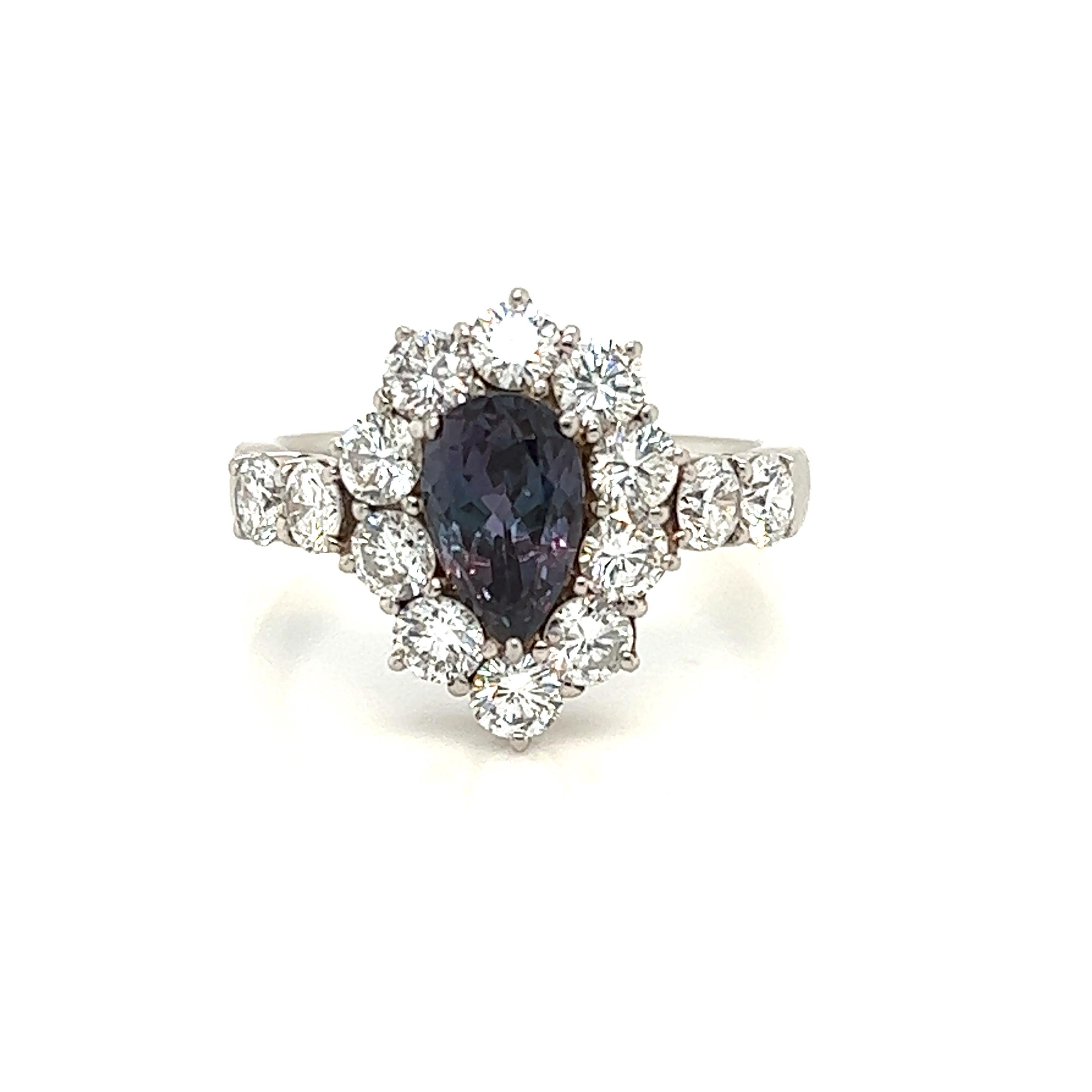 This is a gorgeous natural AAA quality pear Alexandrite surrounded by dainty diamonds that is set in a vintage platinum setting. This ring features a natural 1.35 carat pear alexandrite that is certified by the Gemological Institute of America (GIA)