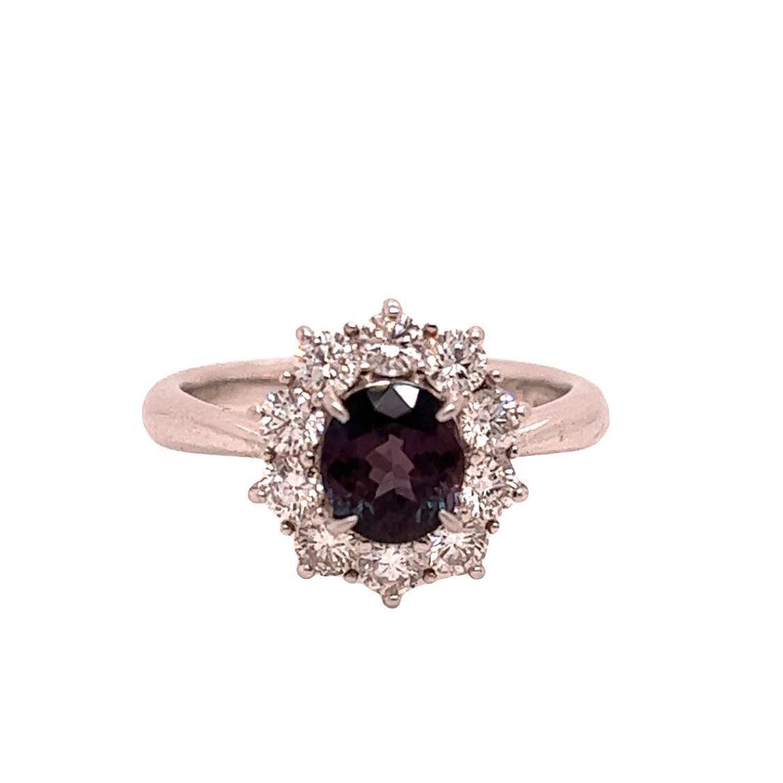 This is a gorgeous natural AAA quality oval Alexandrite surrounded by a dainty diamond halo that is set in a vintage platinum setting. This ring features a natural 1.36 oval alexandrite that is certified by the Gemological Institute of America (GIA)