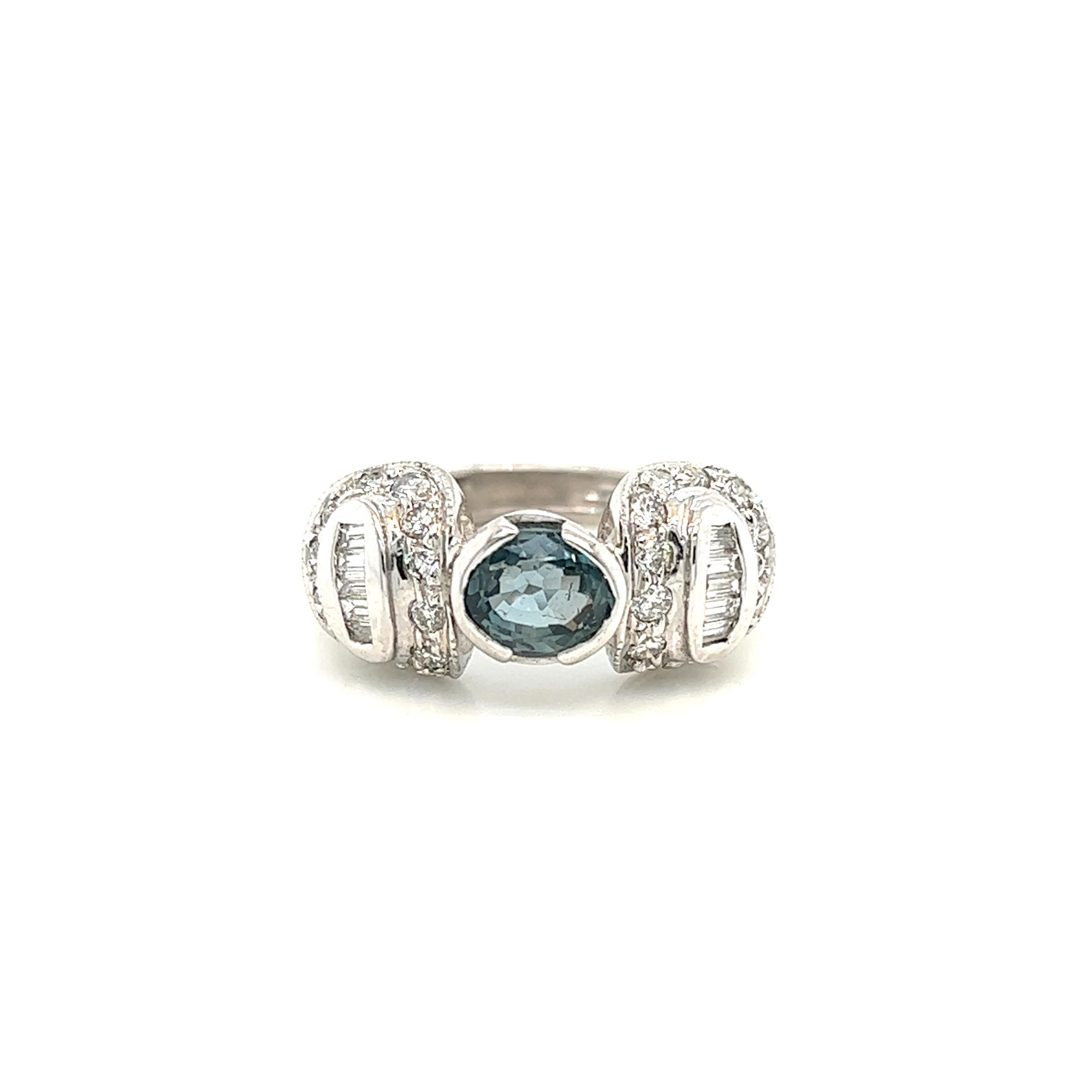 This is a gorgeous natural AAA quality Oval Alexandrite with Baguette diamonds that is set in solid 18K white gold. This ring features a natural 1.38 carat oval alexandrite that is certified by the Gemological Institute of America (GIA). The ring is