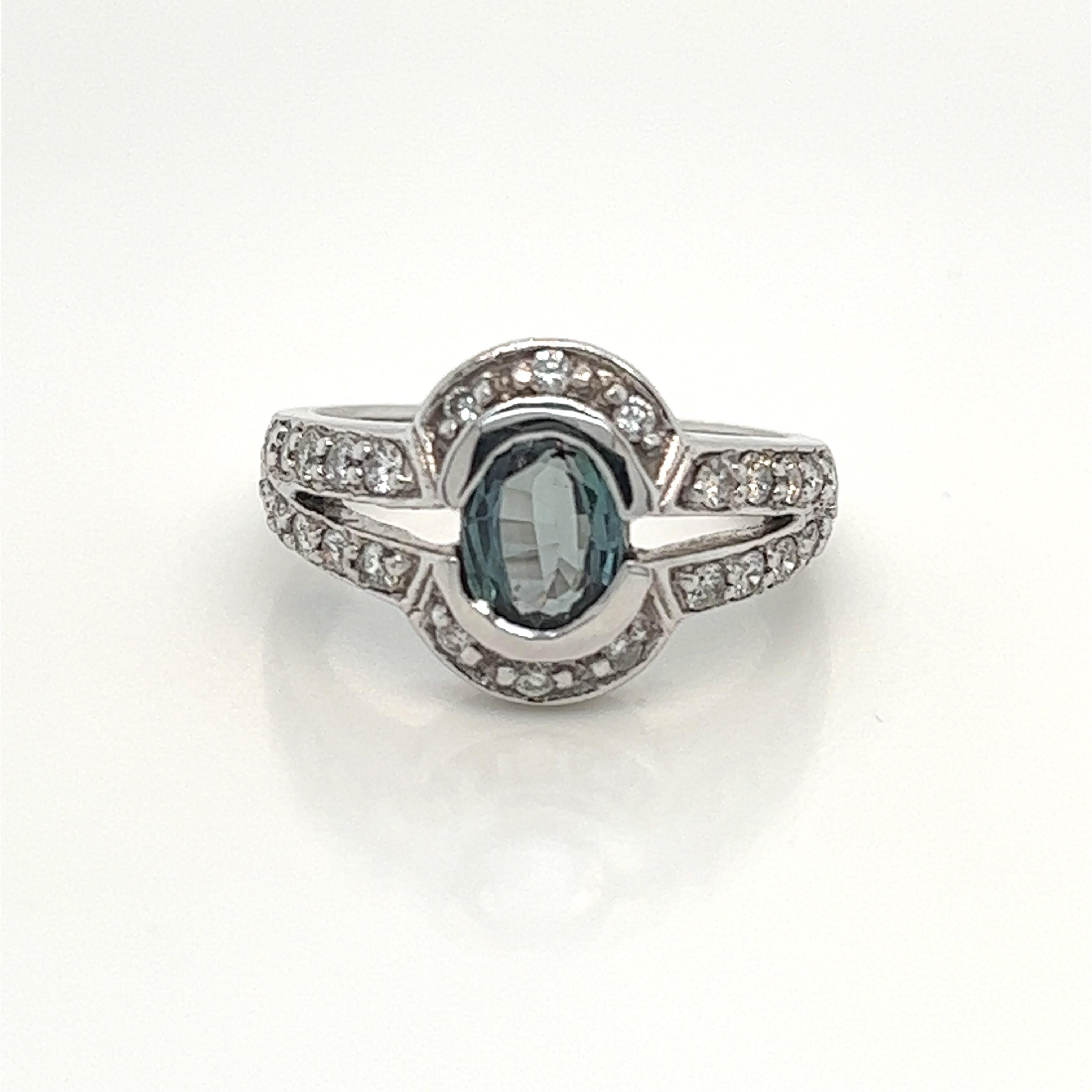 This is a gorgeous natural AAA quality Oval Alexandrite surrounded by dainty diamonds that is set in solid 18K white gold. This ring features a natural 1.40 carat cushion alexandrite that is certified by the Gemological Institute of America (GIA).