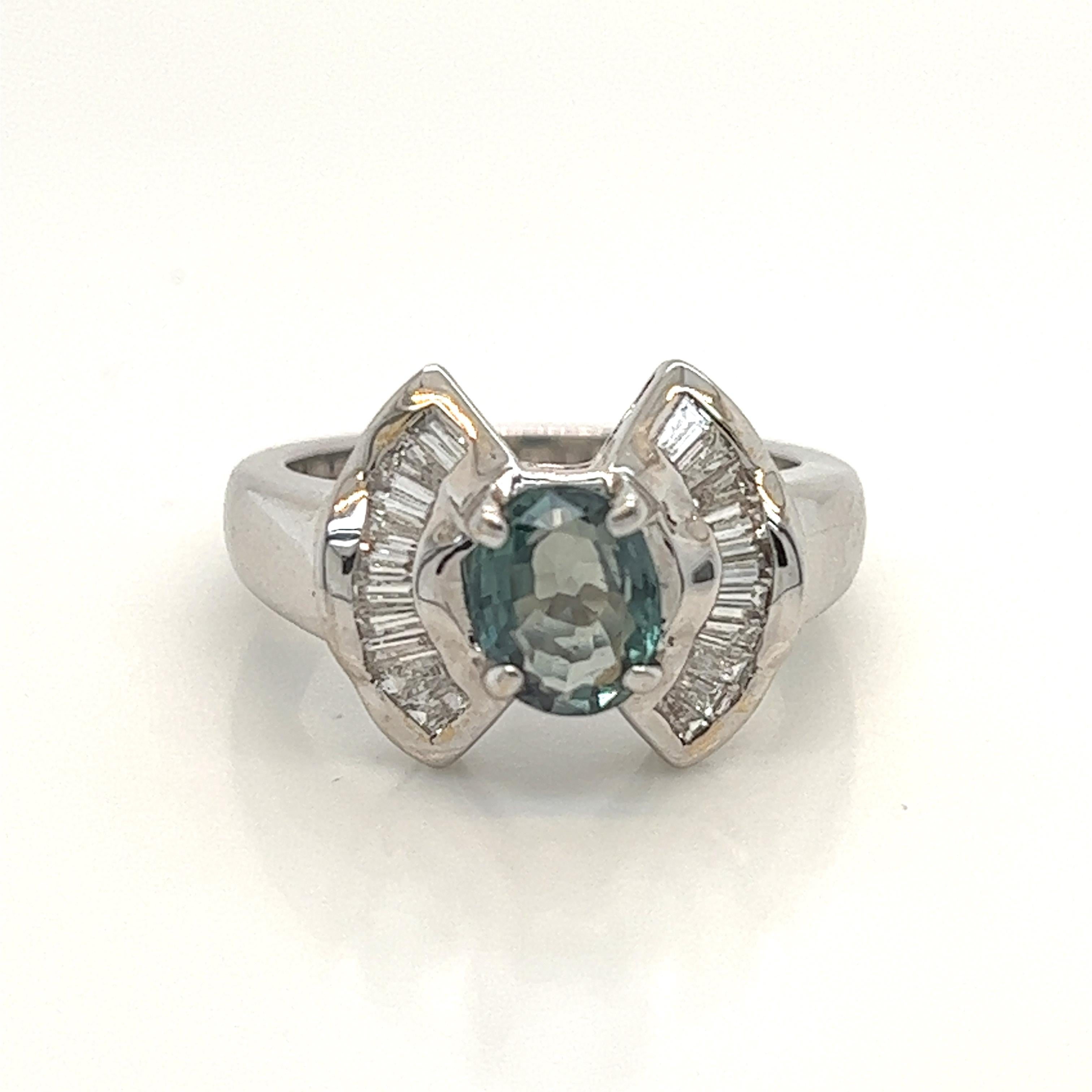This is a gorgeous natural AAA quality Oval Alexandrite with Baguette diamonds that is set in solid 18K white gold. This ring features a natural 1.49 carat oval alexandrite that is certified by the Gemological Institute of America (GIA). The ring is