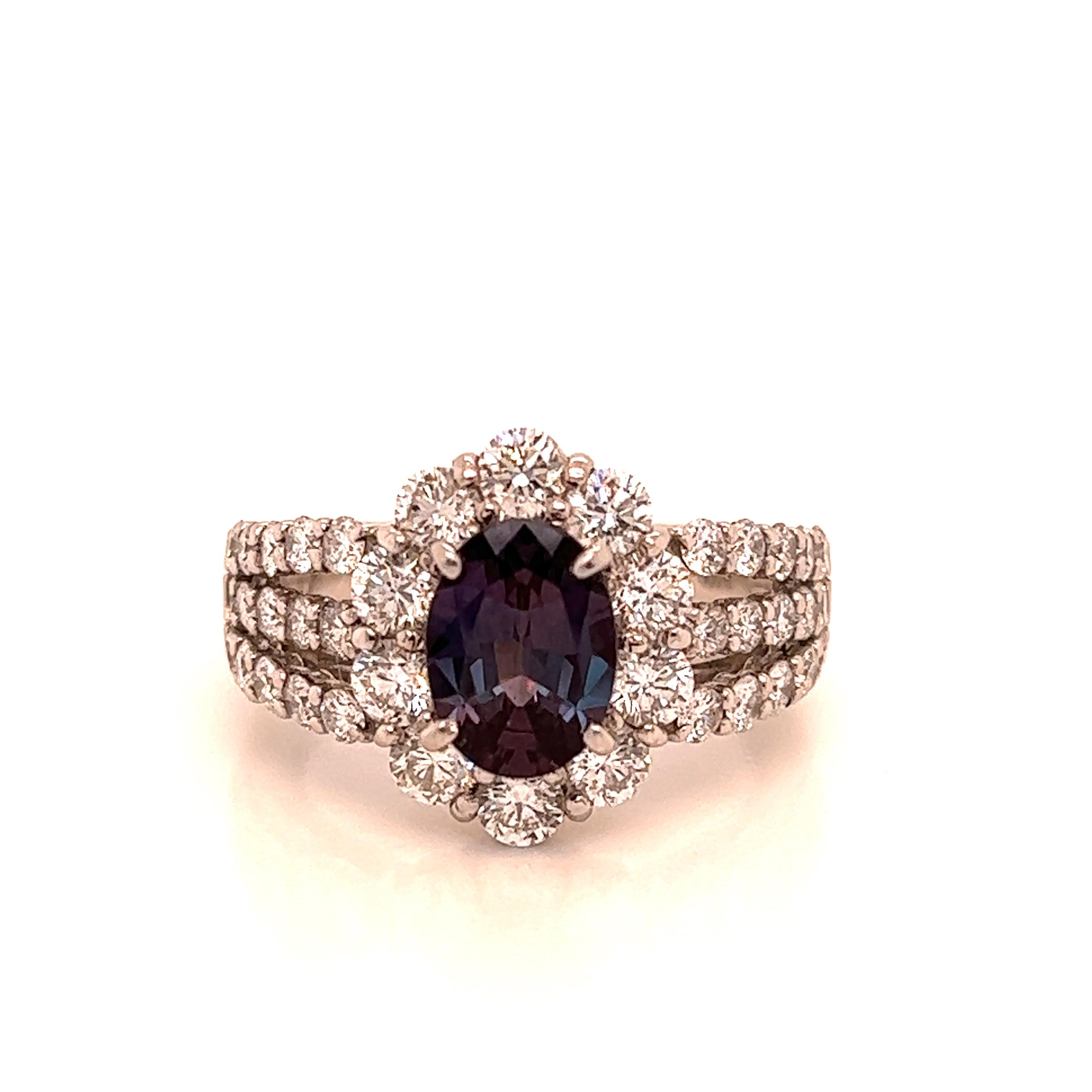 This is a gorgeous natural AAA quality oval Alexandrite surrounded by dainty diamonds that is set in a vintage platinum setting. This ring features a natural 1.51 carat oval alexandrite that is certified by the Gemological Institute of America (GIA)