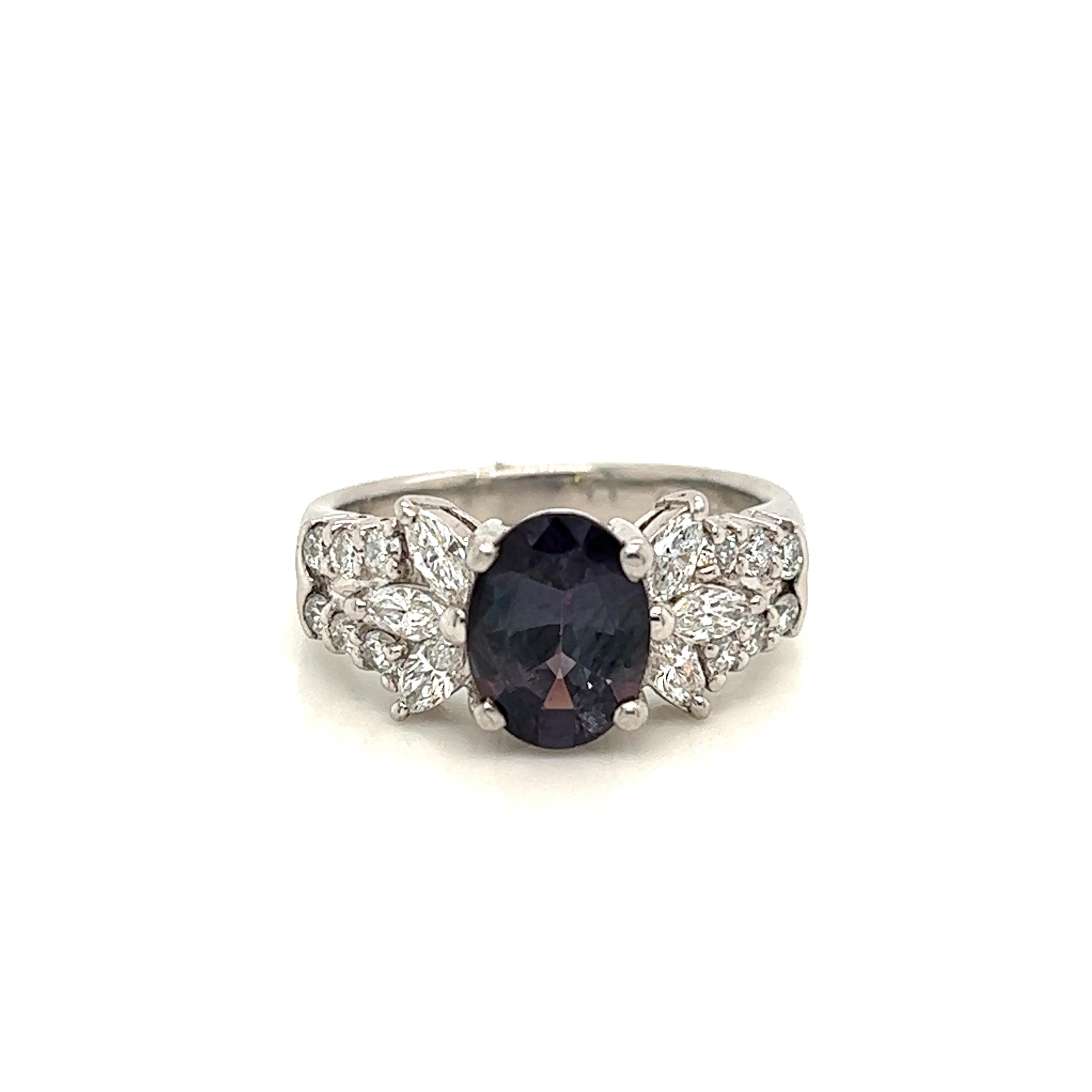 This is a gorgeous natural AAA quality oval Alexandrite surrounded by dainty diamonds that is set in a cocktail platinum setting. This ring features a natural 1.62 carat oval alexandrite that is certified by the Gemological Institute of America