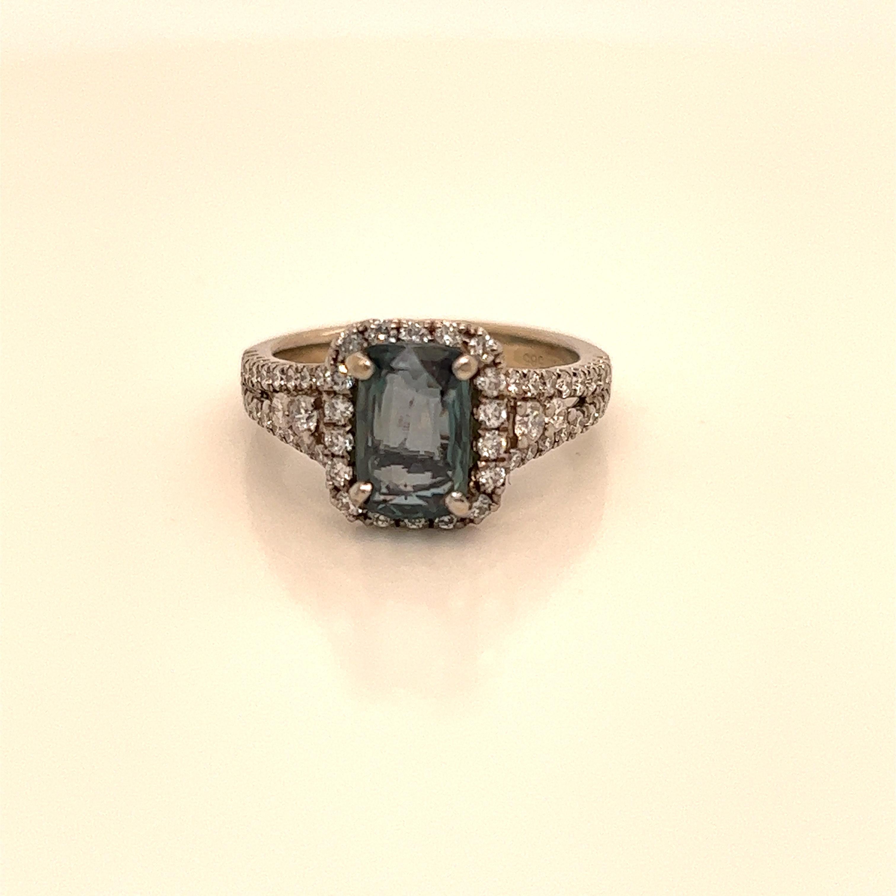 This is a gorgeous natural AAA quality Cushion Alexandrite surrounded by dainty diamonds that is set in solid 14K white gold. This ring features a natural 1.98 carat cushion alexandrite that is certified by the Gemological Institute of America