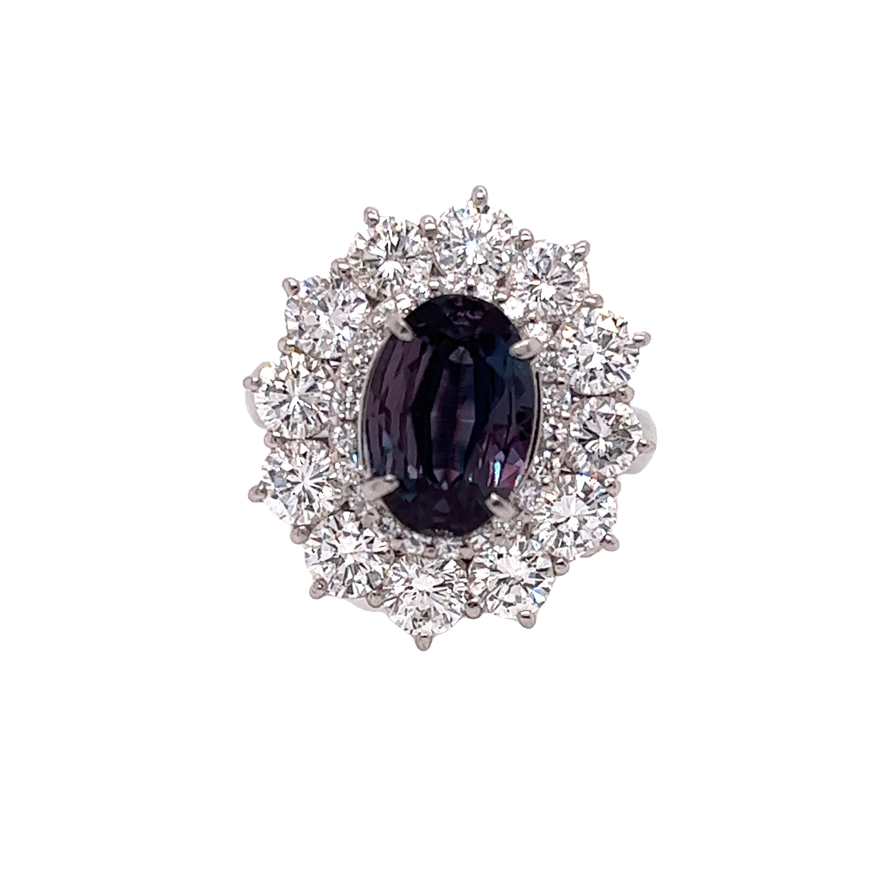 This is a gorgeous natural AAA quality oval Alexandrite surrounded by dainty diamonds that is set in a vintage platinum setting. This ring features a natural 2.16 carat oval alexandrite that is certified by the Gemological Institute of America (GIA)