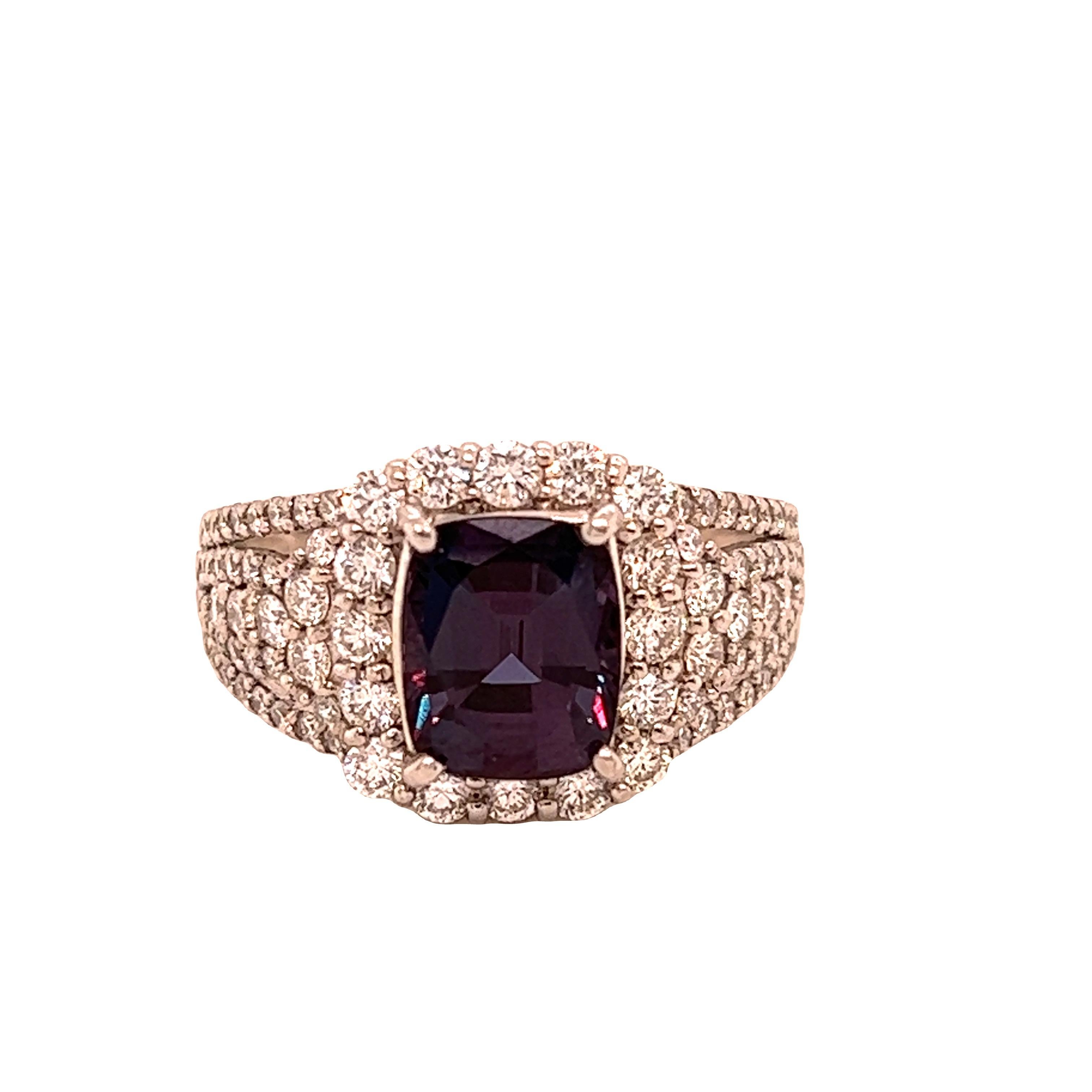This is a gorgeous natural AAA quality cushion Alexandrite surrounded by dainty diamonds that is set in a vintage platinum setting. This ring features a natural 2.21 carat cushion alexandrite that is certified by the Gemological Institute of America