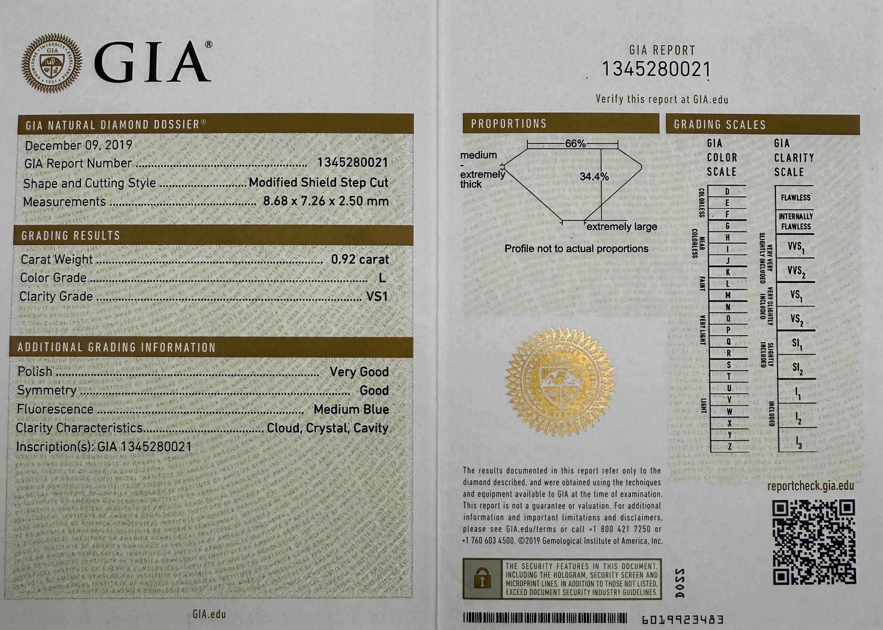 Natural Shield Cut GIA Certified Diamond In An 18k Yellow Gold Bezel Rubover Ring. 

0.92 Carat natural fancy shield cut diamond, fully certified by GIA. It has excellent VS1 clarity and L colour, a very clean and bright stone.

This unique diamond