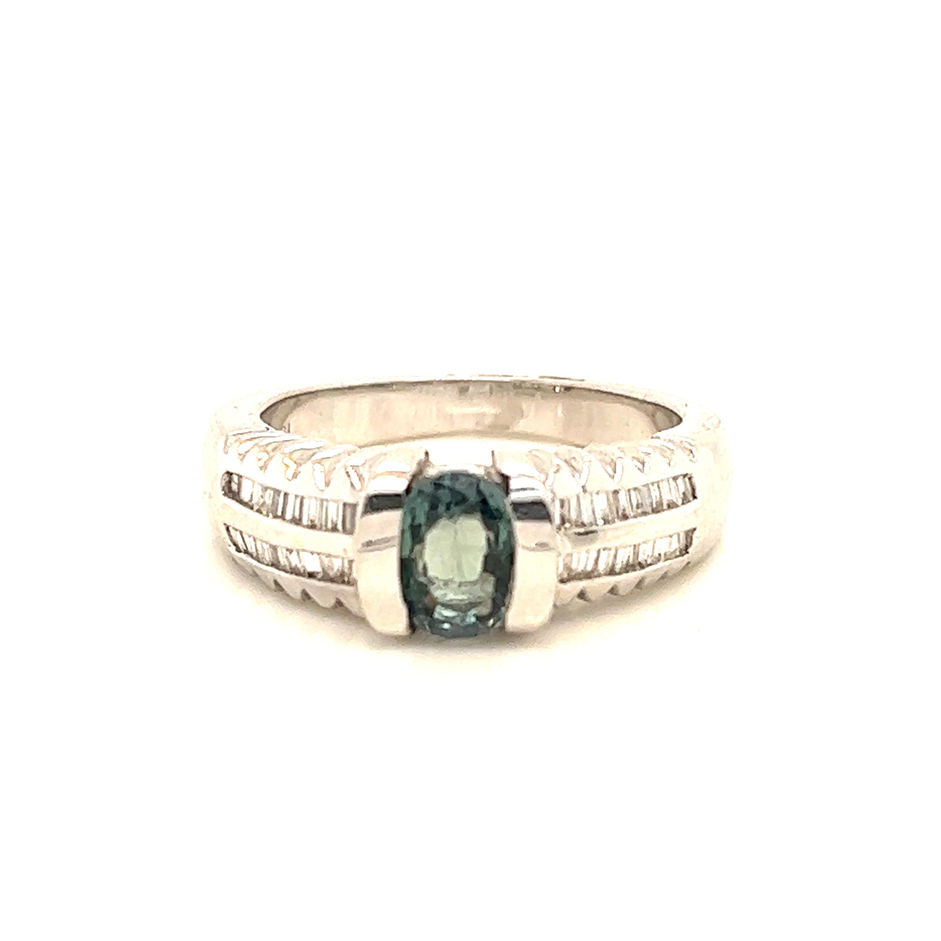 This is a gorgeous natural AAA quality oval Alexandrite surrounded by dainty diamonds that are set in a vintage white gold setting. This ring features a natural 1.13 carat oval alexandrite that is certified by the Gemological Institute of America