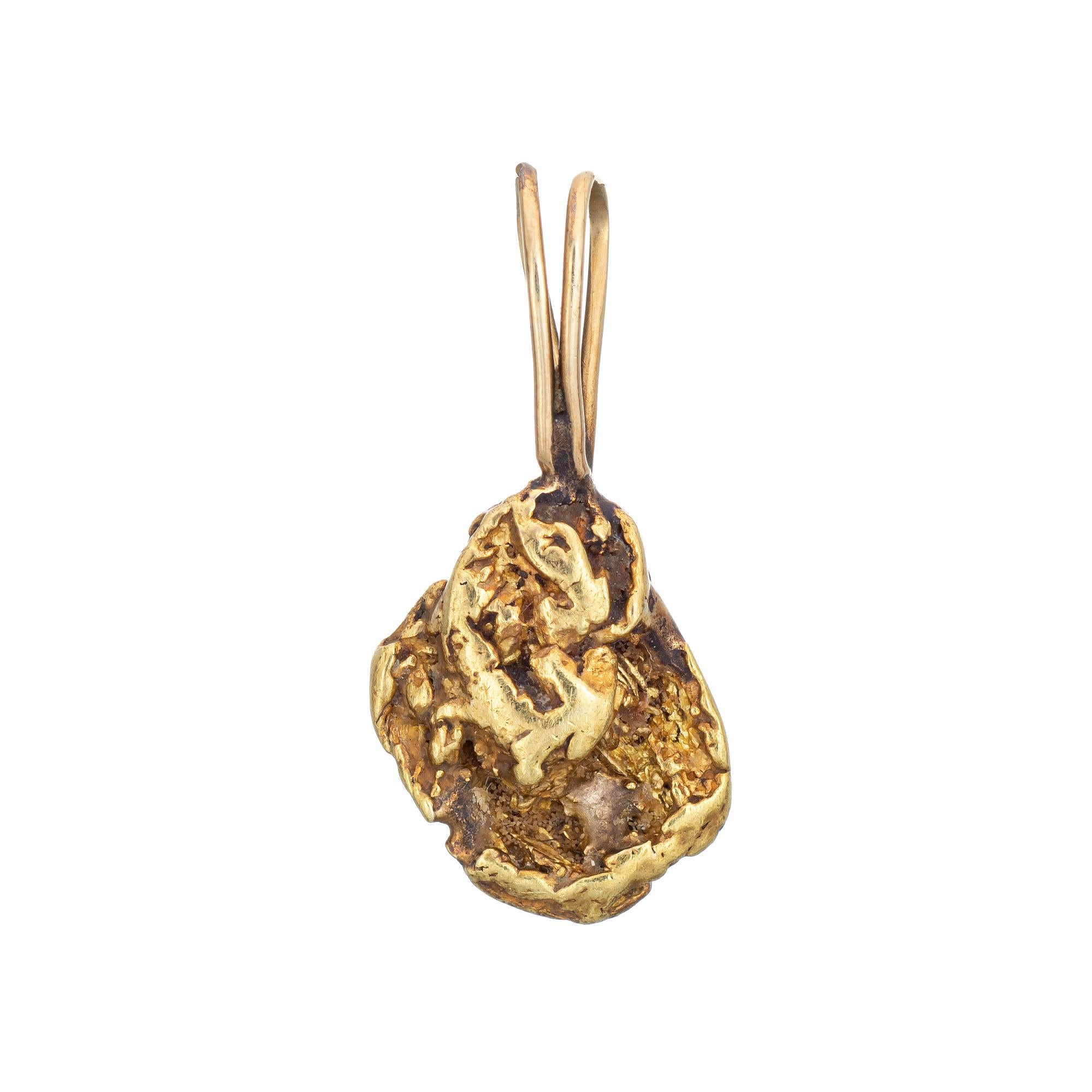 Natural gold nugget pendant fitted with a 14k yellow gold bale. 

The natural mined from the earth gold nugget is attached to a 14 karat yellow gold bale. The gold nugget has its own unique organic look with the brightness of buttery 22k to 24k