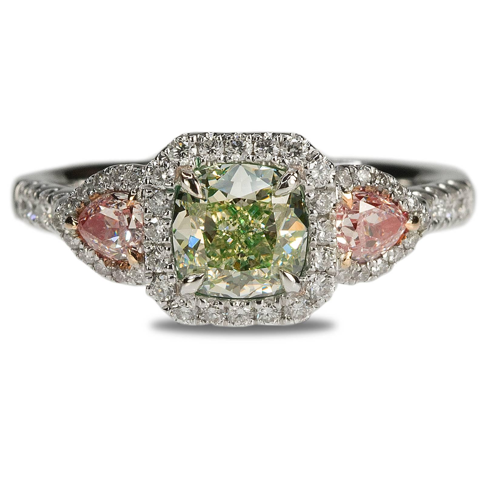 18k Ring with GIA Light Fancy Yellowish Green VS2 Cushion weighing 0.92 carats and 2 Fancy Pink VS pear shapes weighing 0.30 carats and 50 round brilliants weighing 0.31 carats.