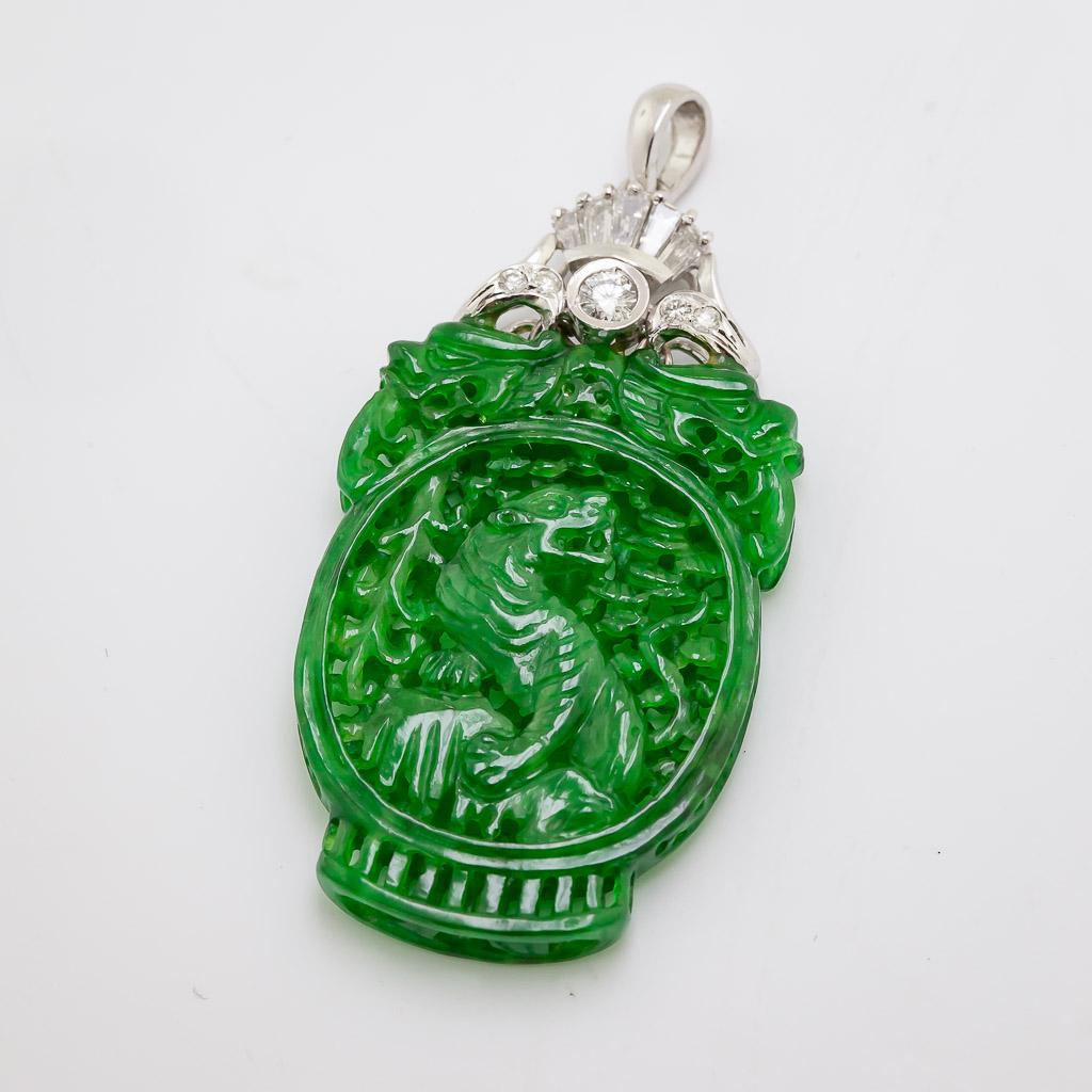 The detail in this 32.45 X 22.75 X 4.45 mm carved plaque is so rare and intricate, 
it is carved from a single piece of jadeite, carved from the outside to the inside, 
featuring two different themes on front a framed tiger amongst trees, surmounted