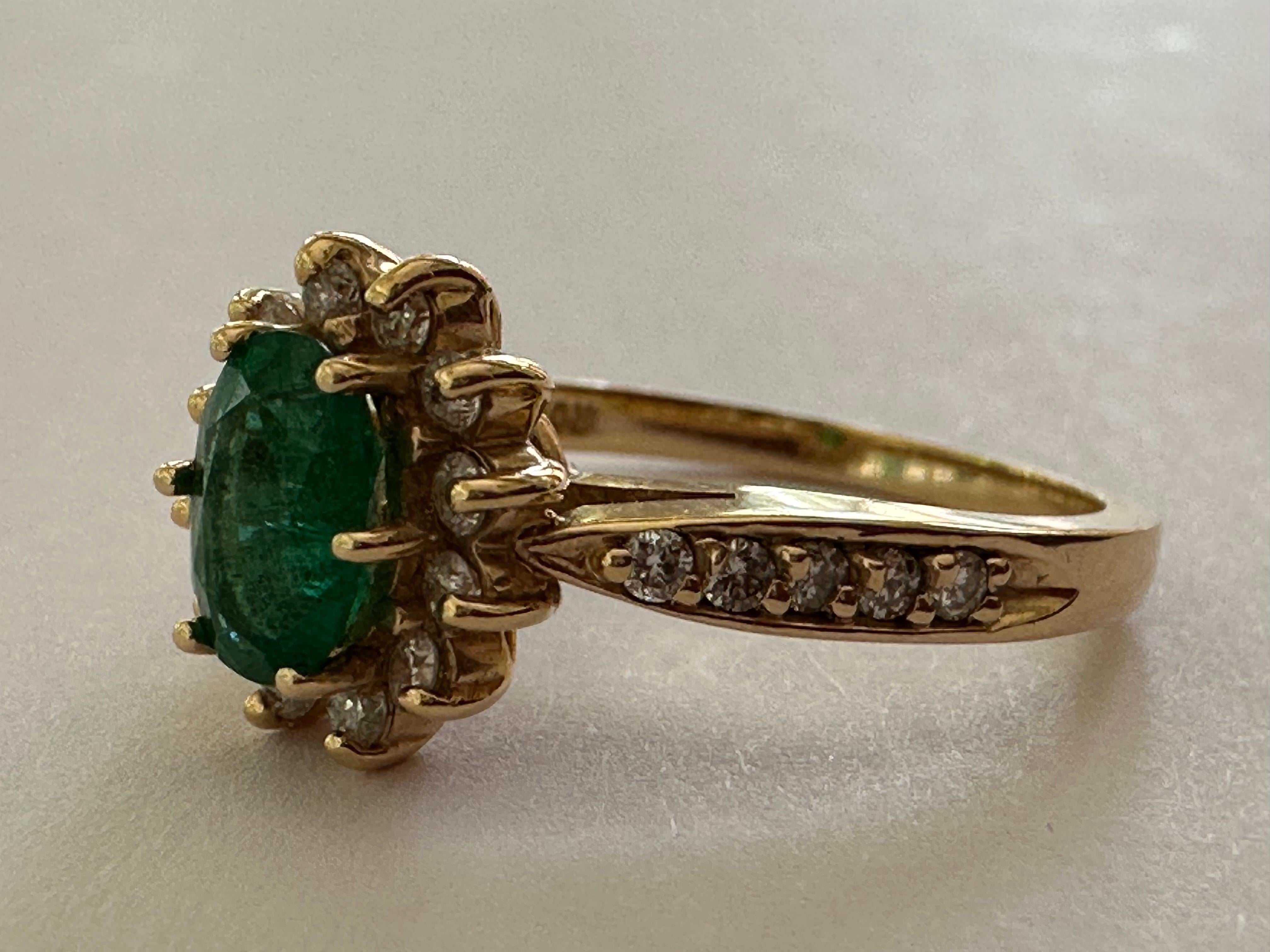 Crafted in the 1940s, this Retro-era ring features a beautiful 0.75-carat natural green emerald. The oval-cut gem is surrounded by 0.40 carats of sparkling round diamonds and set in 14K yellow gold. 