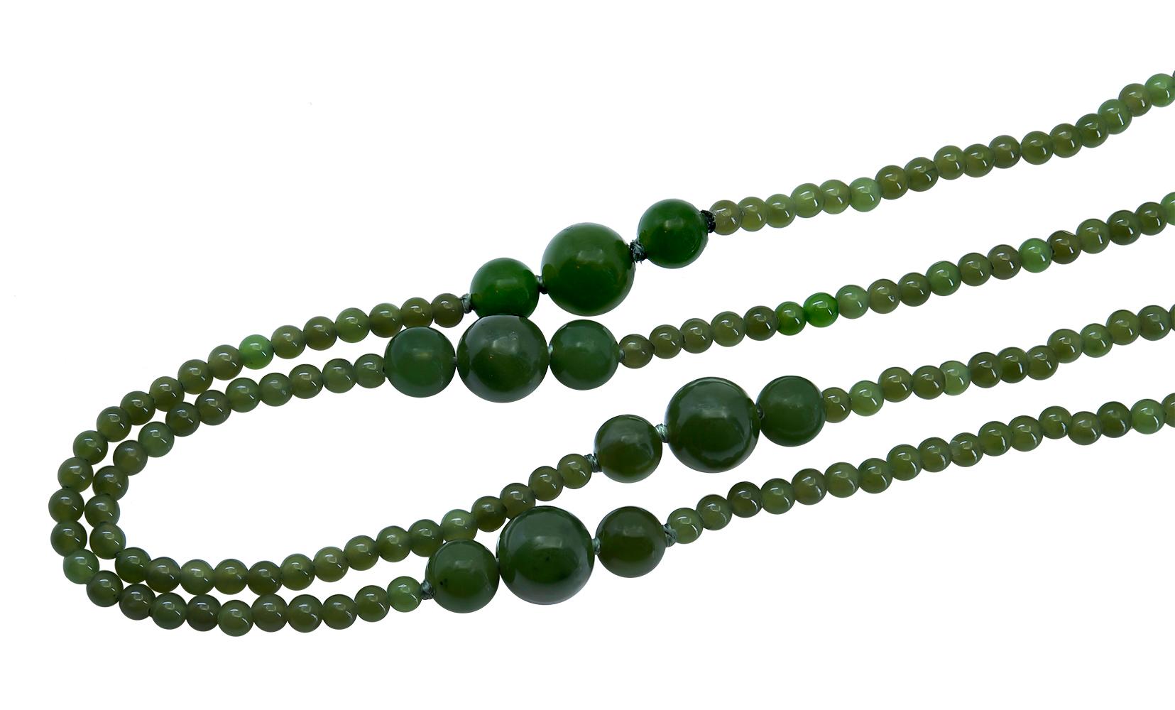 A 44 inch Natural Green Jade Necklace with a trinity of deep green 6 and 8 mm jadeite round beads connected by a string of consecutive 3 mm round jade beads that are lighter in tone creating a well balanced contrast to the darker toned trinity of