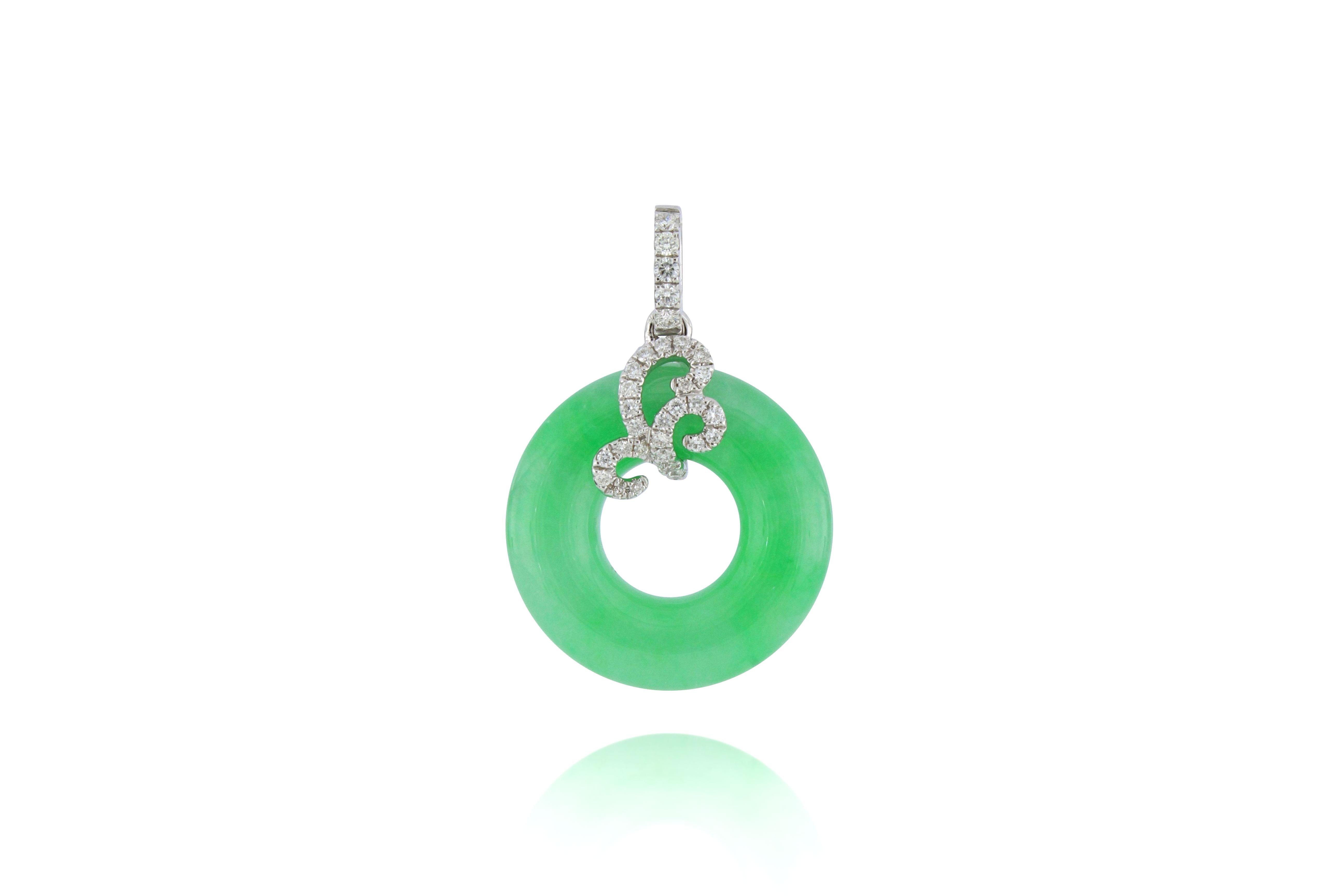 A translucent bright green natural jadeite pendant in perfect round shape, decorated with round brilliant-cut diamonds, weighing 0.178 carats in total, mounted in 18 karat white gold. 
The company was founded one and a half centuries ago in Macau.