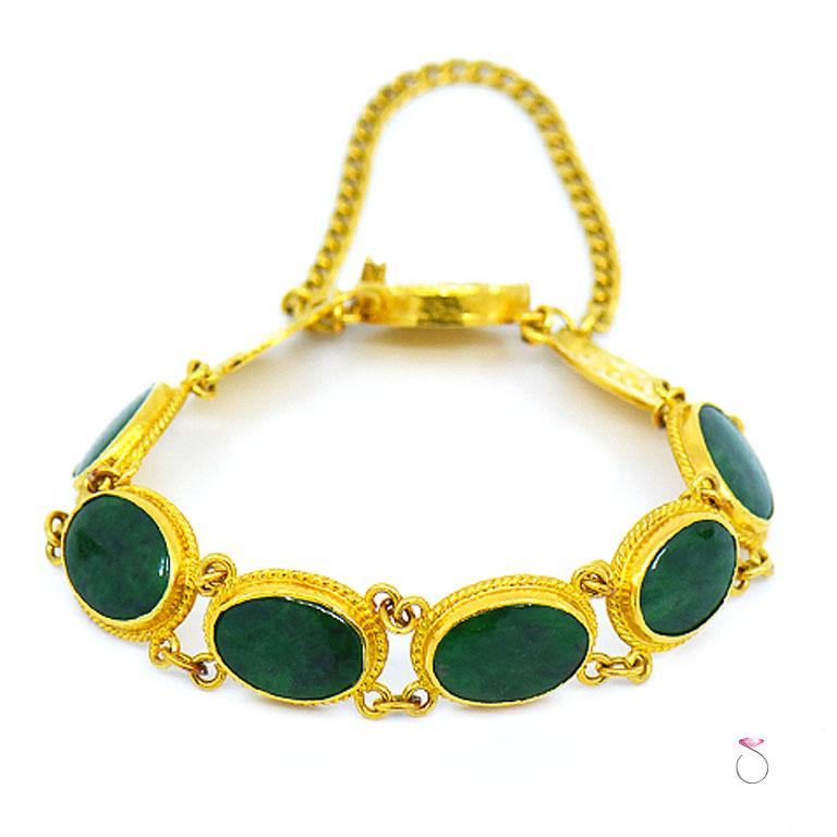 Beautiful vintage natural deep green Jadeite Jade sectional Bracelet handmade in 24K gold. This magnificent bracelet features 6 oval shape cabochon Jade pieces, each piece is bezel set and surounded by a decorative rope design at the base. Each