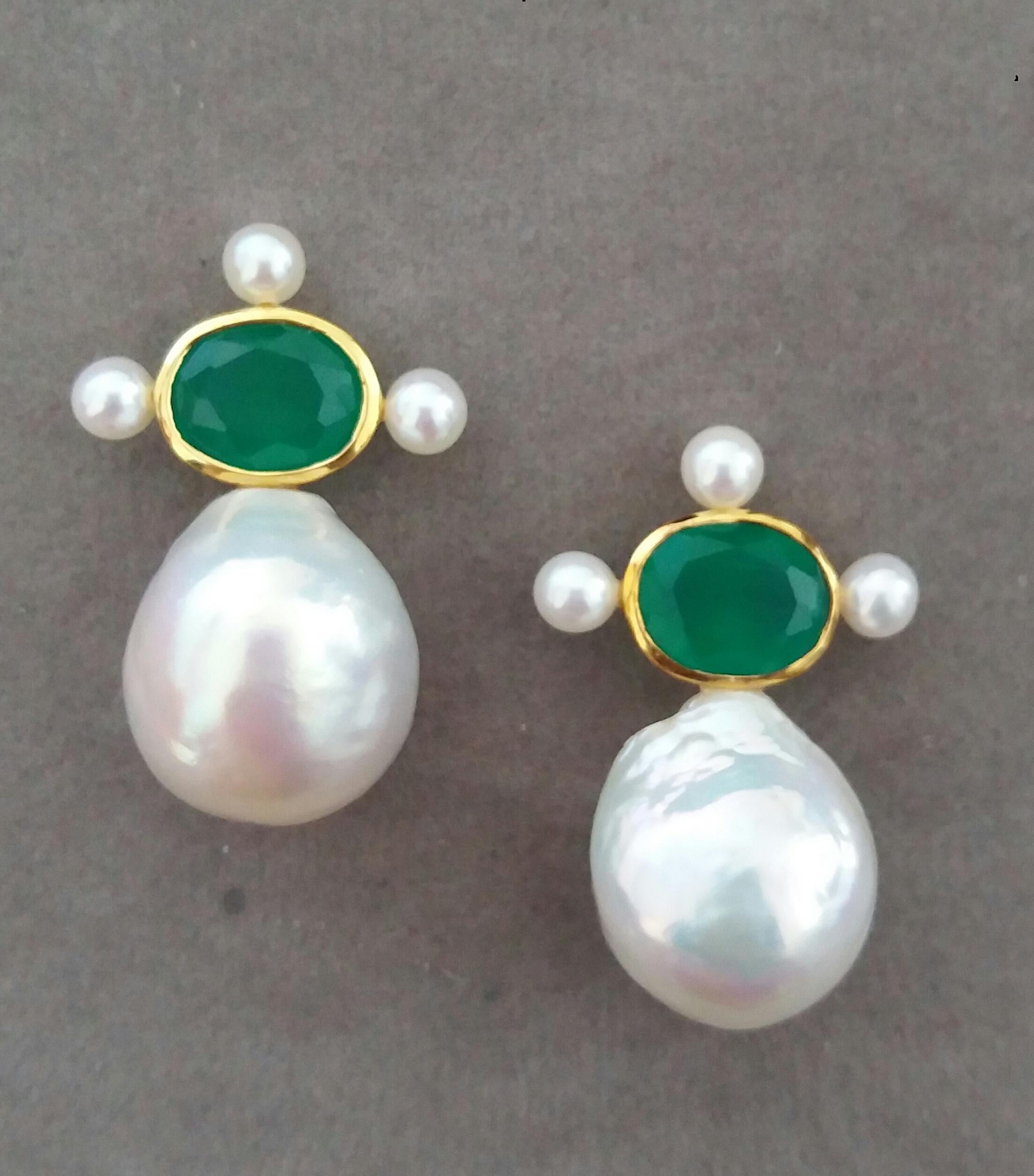 These elegant and handmade earrings have 2 Faceted Oval  Natural Green Onyx measuring 8 x 10 mm set in a 14 Kt yellow gold bezel with 3 small round pearls of 3 mm on 3 sides at the top to which are suspended 2 very good luster White Pear Shape