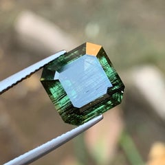 Natural Green Peridot with Dense Ludwigite Needle Inclusions 6.66 Ct Emerald Cut