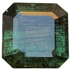 Natural Green Peridot with Dense Ludwigite Needle Inclusions 6.66 Ct Emerald Cut