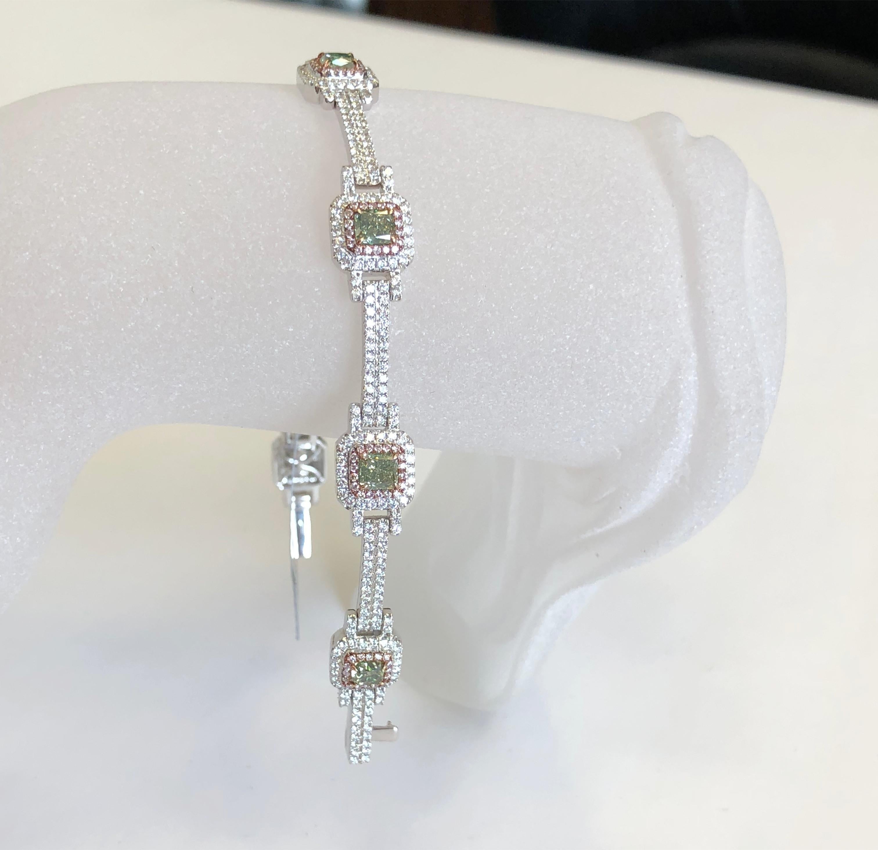 Stunning bracelet with 3.82 carats of green diamonds and 3.10 carats of white and pink diamonds in 18k white gold.  Flexible and dainty handmade mounting.  Perfect for everyday stacking with other bracelets and watch or for a special occasion.  