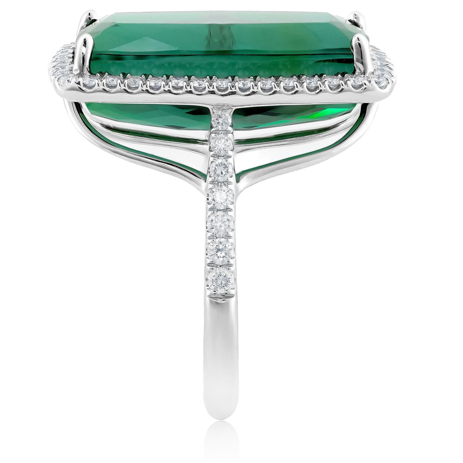 Discover the bold elegance of this 14K white gold ring, showcasing a stunning natural green tourmaline accented by dazzling diamonds. The cushion-cut green tourmaline, with its vibrant hue and impeccable clarity, is complemented by brilliant