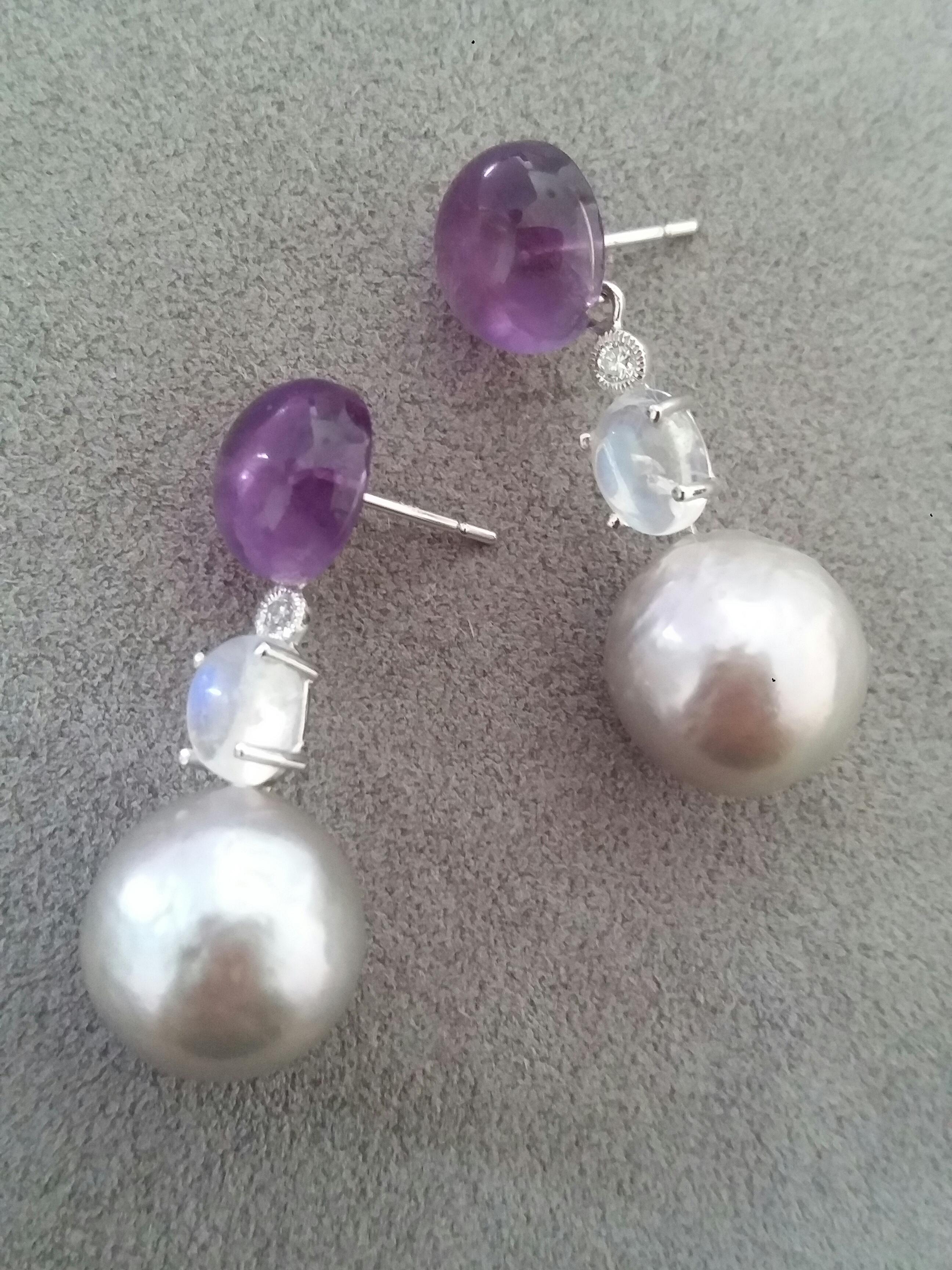 Tops are 2 Amethyst round cabochons,then 2 oval Monstones and Diamonds set with White Gold are holding 2  Grey Baroque Pearls

In 1978 our workshop started in Italy to make simple-chic Art Deco style jewellery, completely handmade and using the