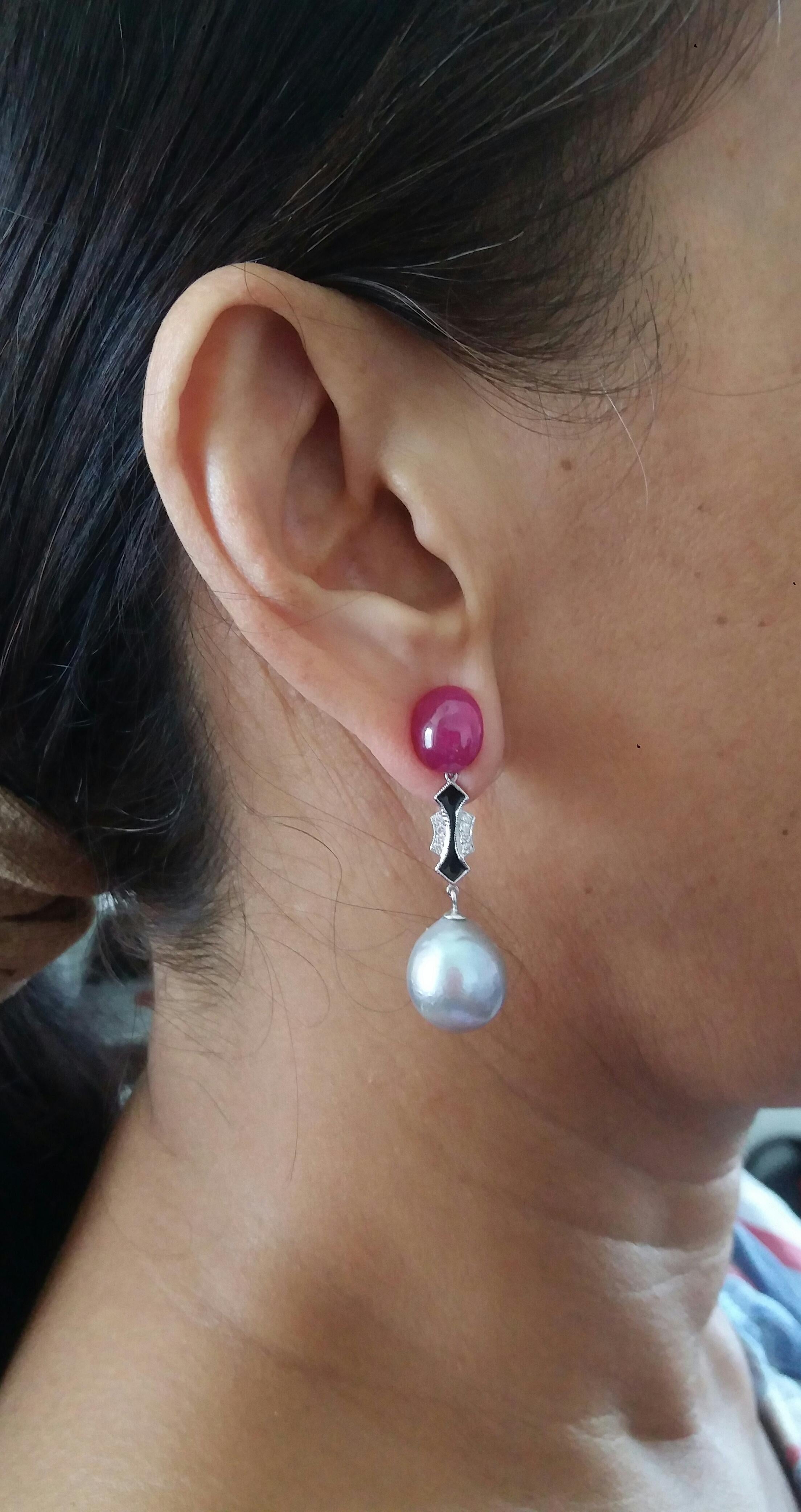 the top has 2 large ruby cabochons, then we have a central part in white gold diamonds black enamel , finally the bottom is composed of 2 natural color grey  baroque pearls of 12 mm. diameter.
In 1978 our workshop started in Italy to make