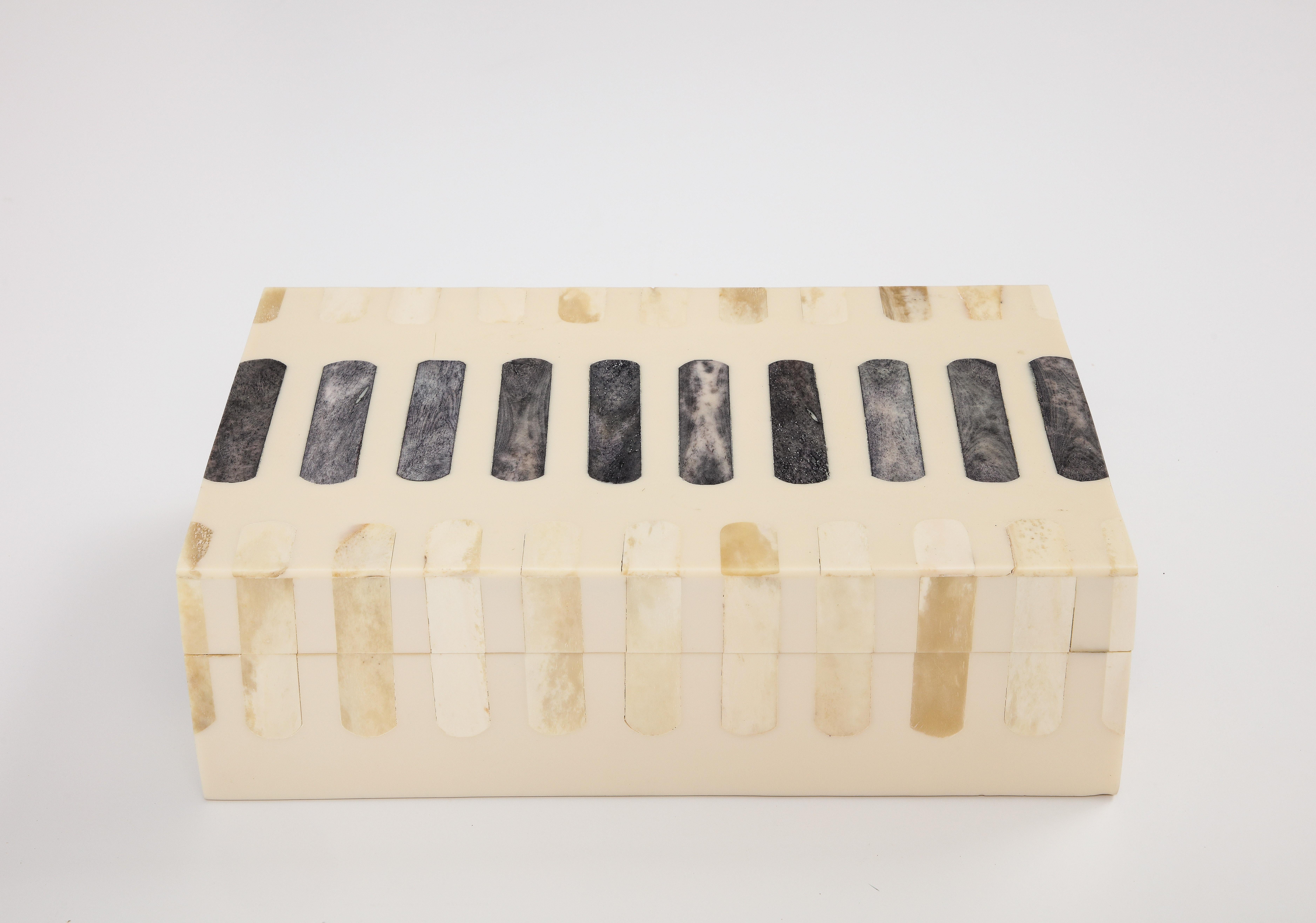 Handmade natural bone box inlaid with grey bone oblong segments, lined in wood. A great storage solution for your desk or coffee table.