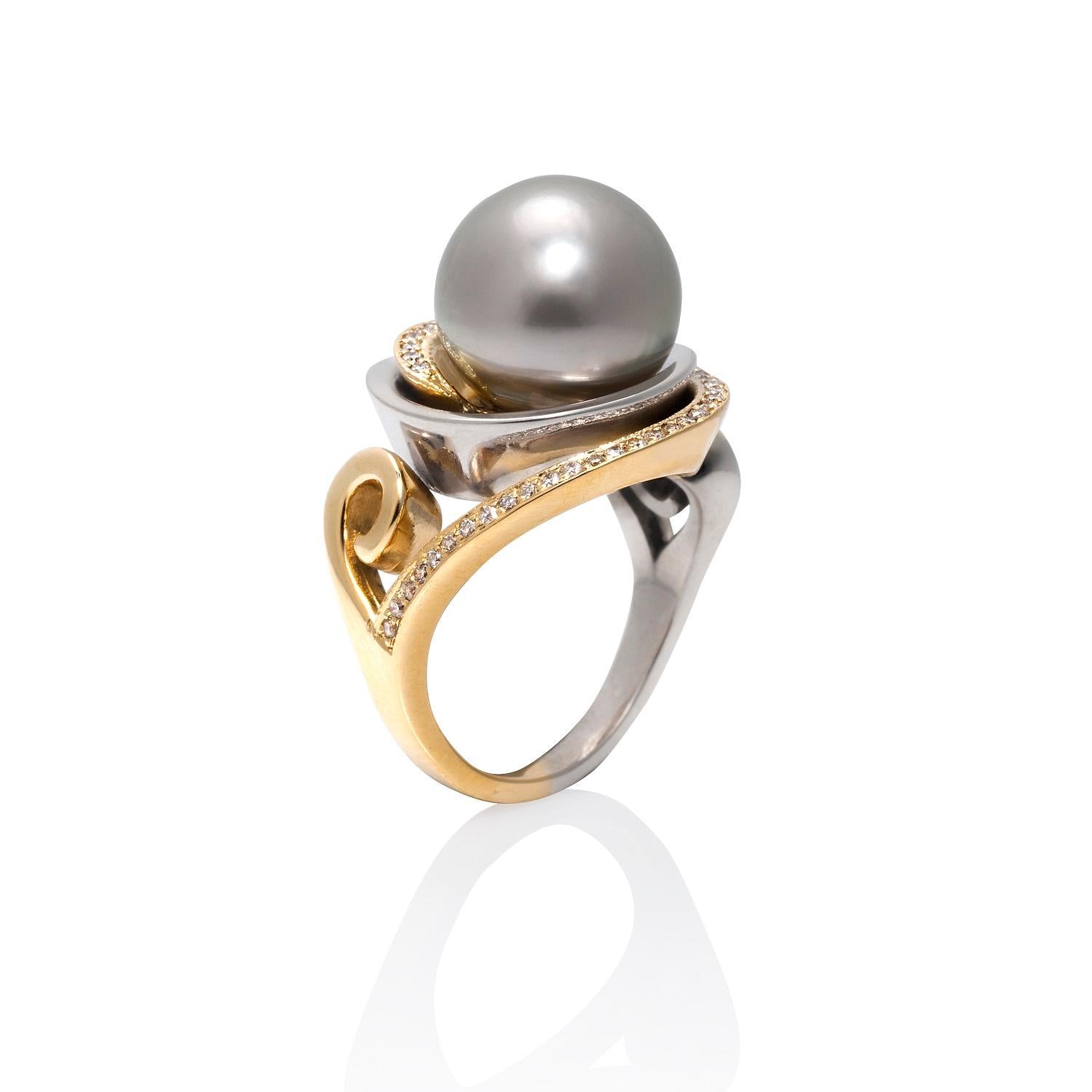 The Nebula Cocktail Ring with the 12mm natural Black Tahitian pearl is a ring with interlocking spirals of 14ky and argentium sterling silver that wrap around the pearl. The 14k spiral is pave set with sixty-eight 0.8mm VS2-SI1 diamonds.

This ring