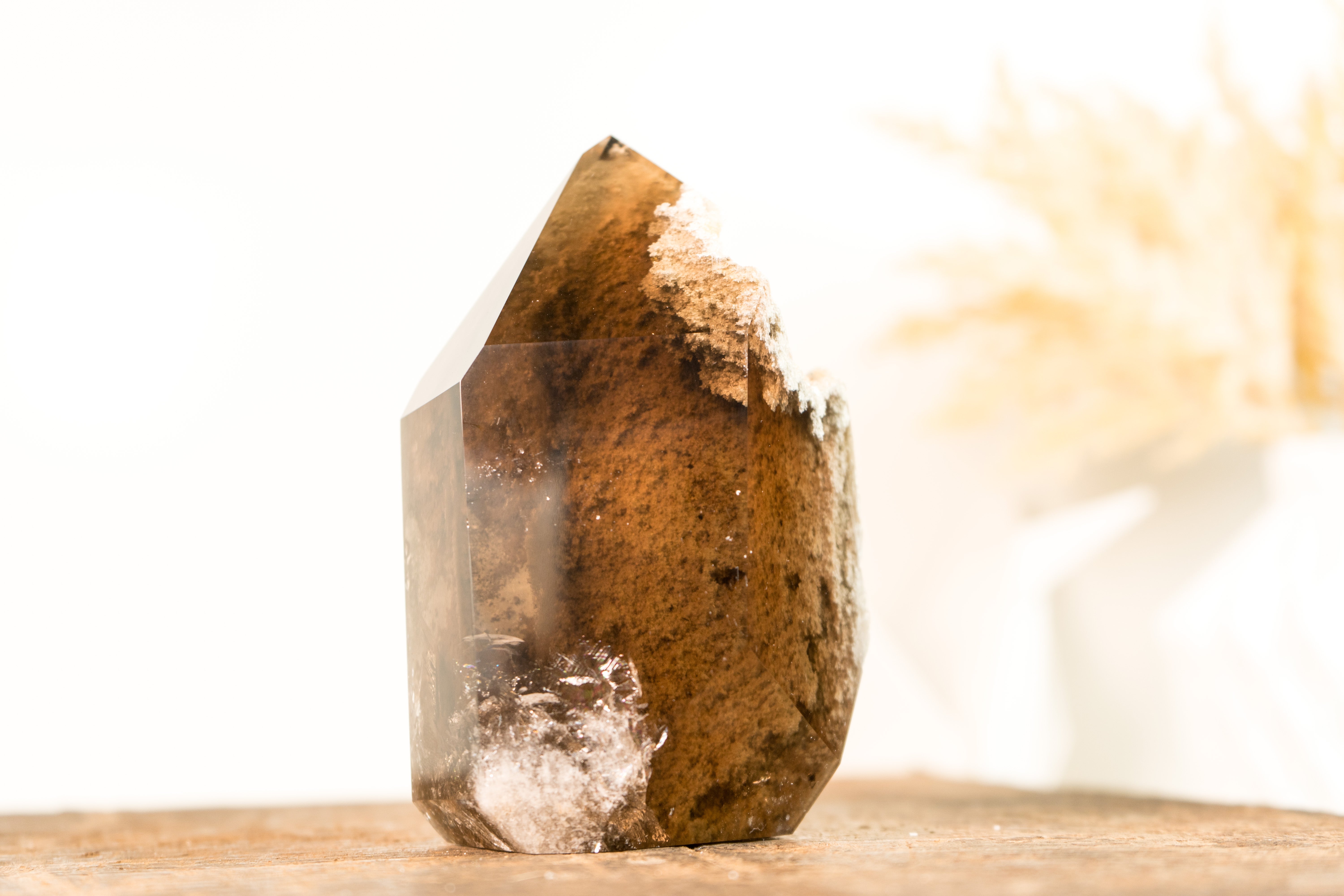 A natural artwork that began forming millions of years ago, this Bronze Smoky Quartz offers a window to the past, encapsulating a landscape within a crystal. This Bronze Smoky Crystal makes a valuable addition to your crystal collection or a
