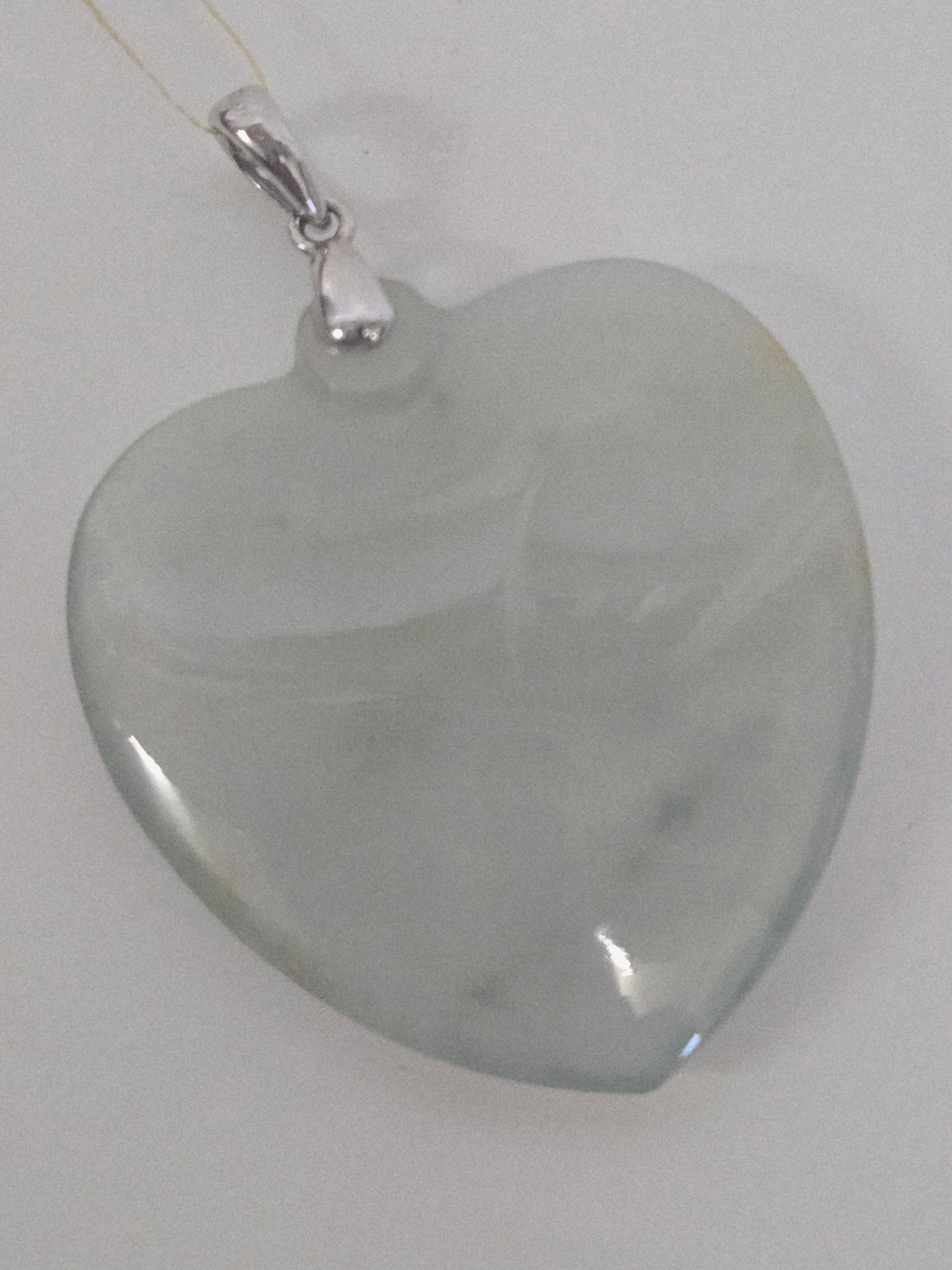 This is a beautiful natural jadeite jade carved heart-shaped pendant, featuring an icy, translucent light green hue with subtle natural brown jadeite inclusions. The jadeite measures approximately 3.0 cm (W) × 3.2 cm (L) and displays a soft,