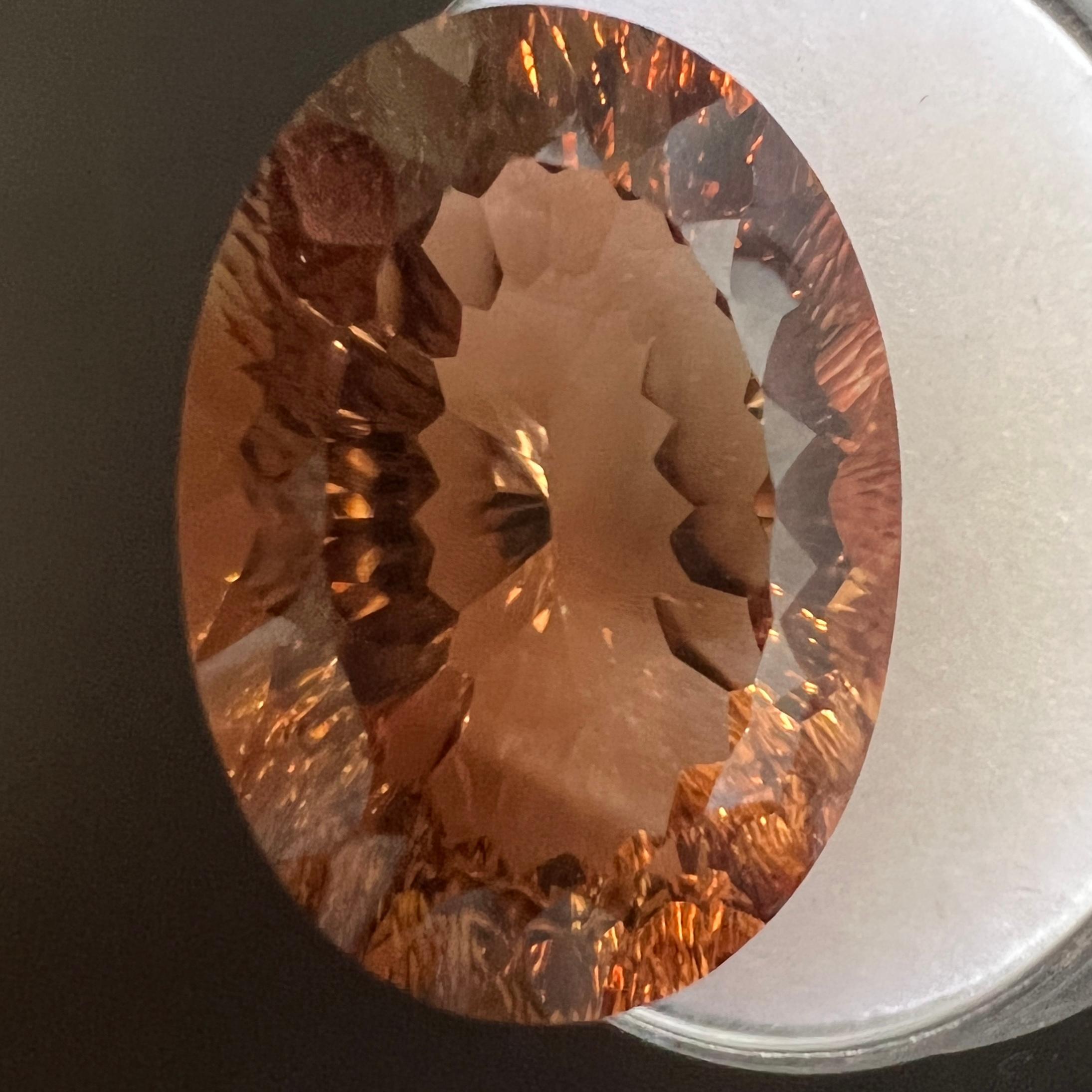 Natural Imperial Topaz Gemstone.

21.83 Carat with a stunning imperial orange colour and excellent clarity. Very clean gem. Also has an excellent fancy oval concave cut and polish to show great shine and colour, would look lovely in