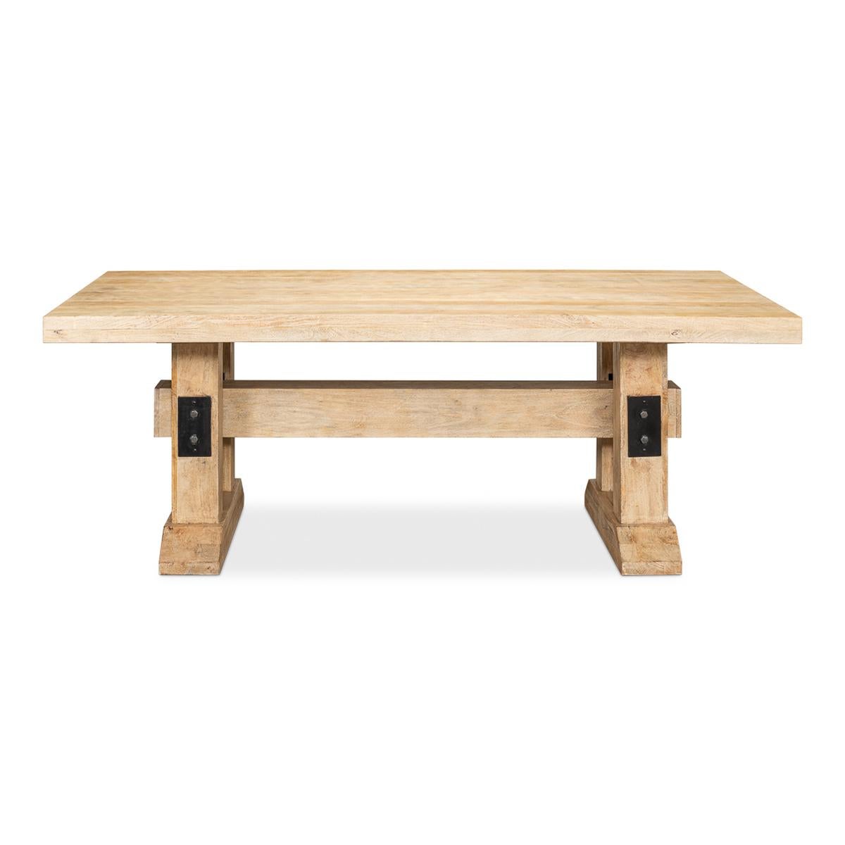 Natural Industrial Farmhouse dining table. In our Sienna finish, this natural wood dining table is constructed of solid wood and sits on two massive block pedestals anchored together with an equally massive beam all held together with industrial