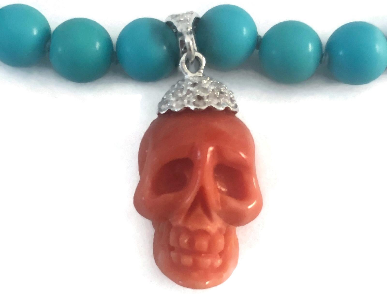 Stunningly  beautiful blue Sleeping Beauty necklace of 8-8,5mm turquoise beads with a natural Italian hand-carved skull attached to an 18k white gold bale and cap encrusted with diamonds.  This turquoise and coral necklace has an 18k white gold 