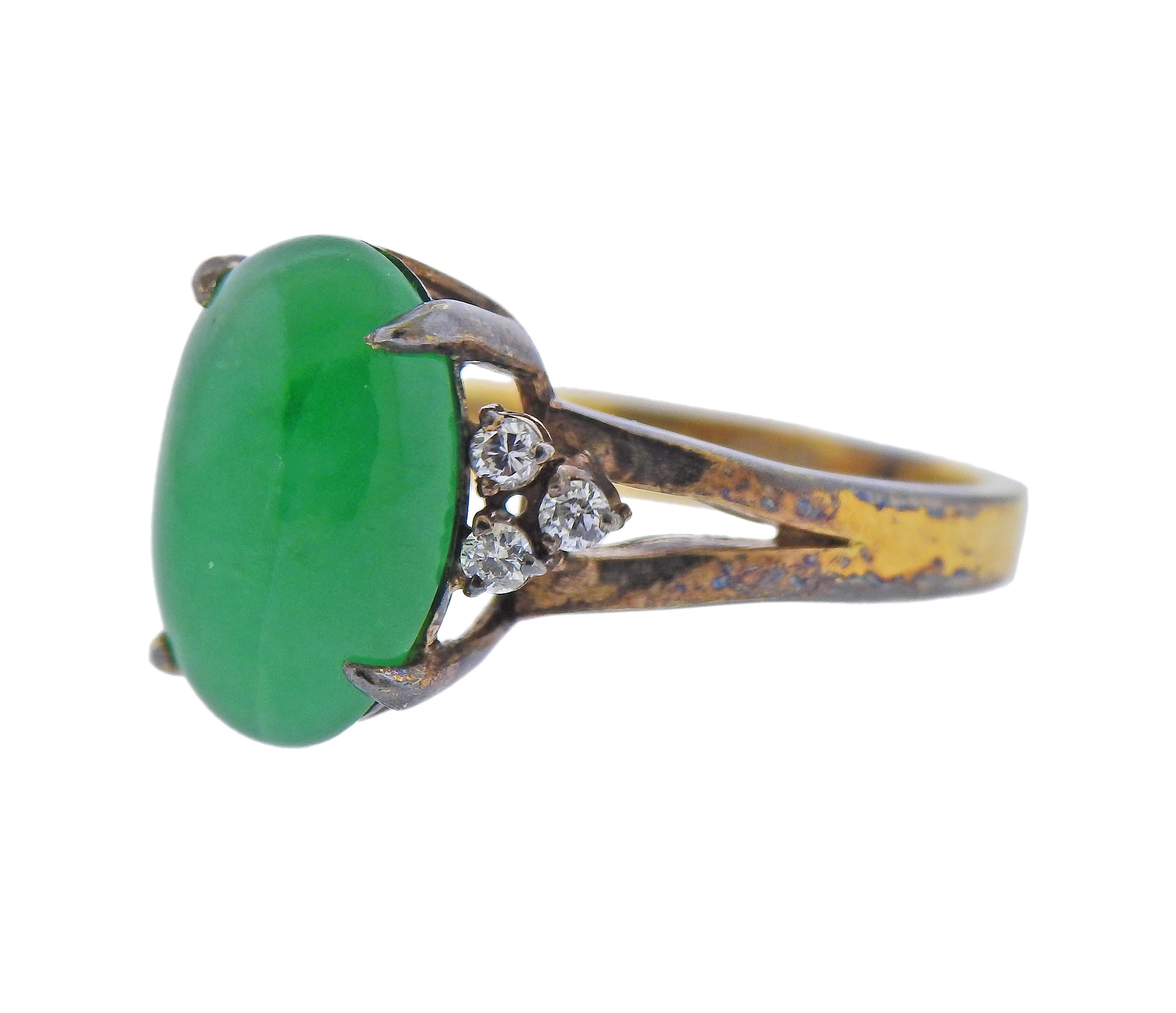 14k gold ring, set with a natural color type A Fei Cui (jade) , measuring approx. 21.61 x 8.51 x 4.17mm, surrounded with 6 side diamonds. Ring size - 5.5. Marked 585. Weight - 4.3 grams.
