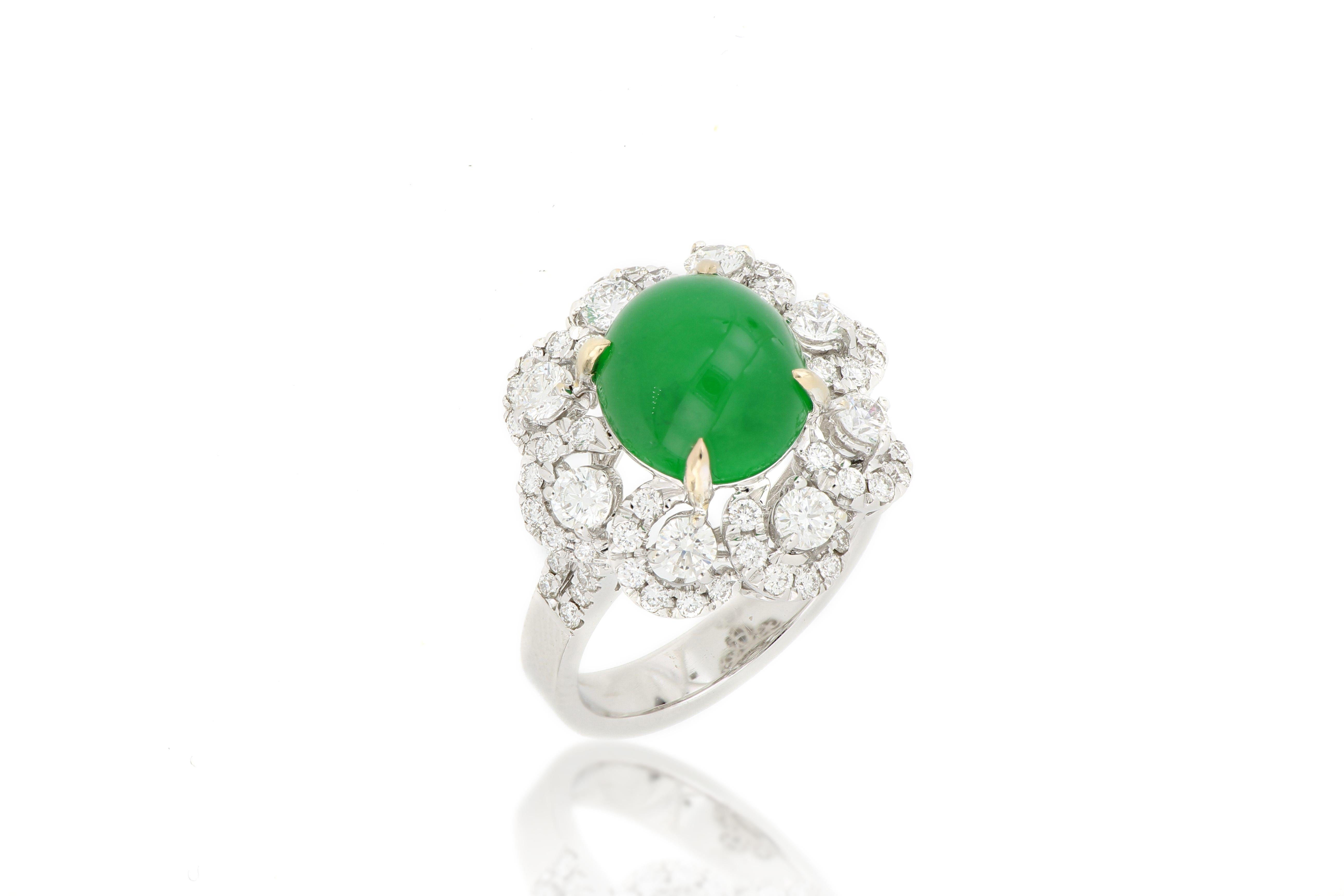 
A fabulous ring set with a round natural jadeite cabochon of rich emerald green colour and very good translucency, surrounded by clusters of round brilliant-cut diamonds is in the shape of petals,  total weighing 1.30 carats, mounted in 18 karat