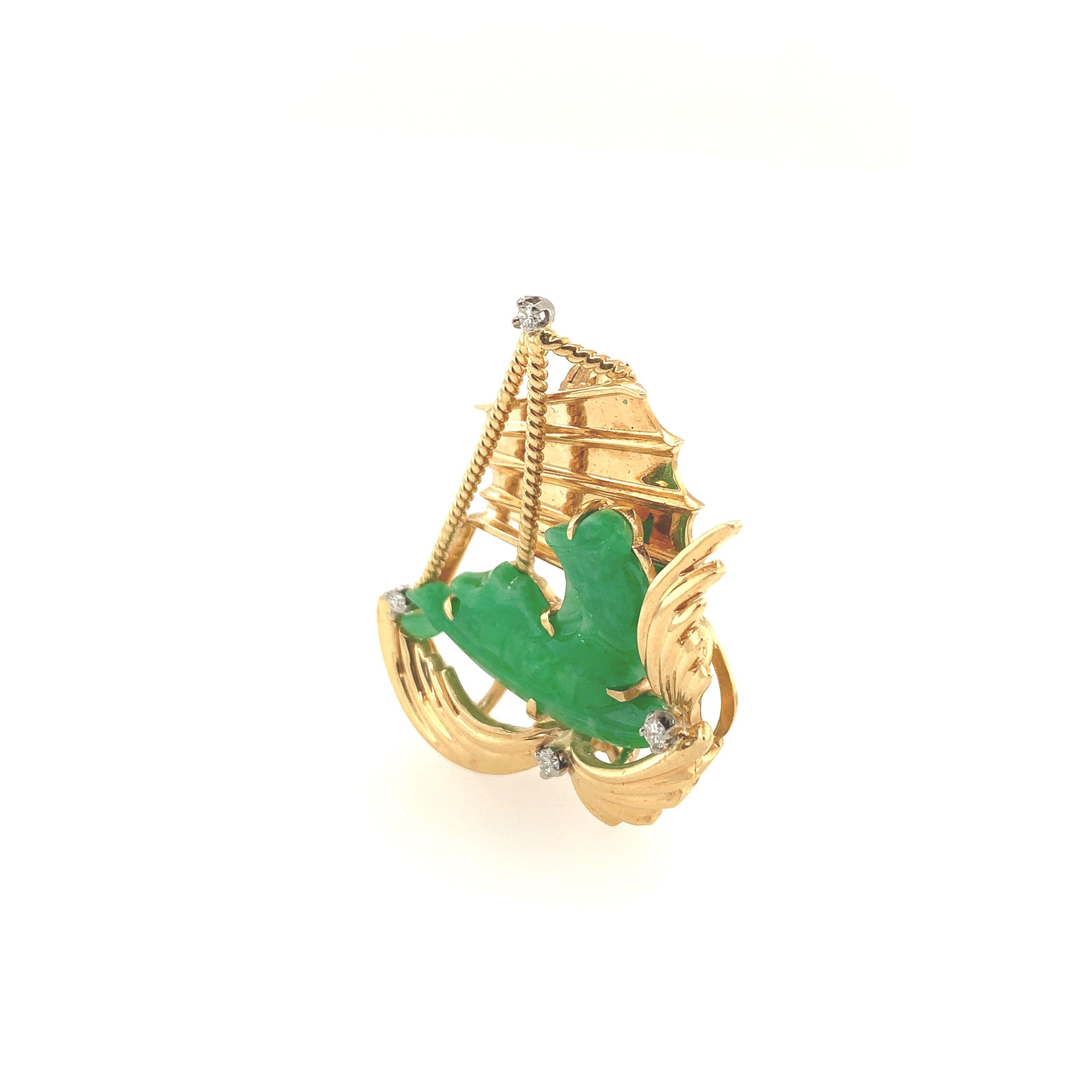 A vintage natural carved jade and 14K yellow gold sailboat brooch boasting (4) four round brilliant cut diamonds weighing approximately .08ct tw. Fitted with pin and safety catch - ready to sail away... 
These iconic ships have long been one of the