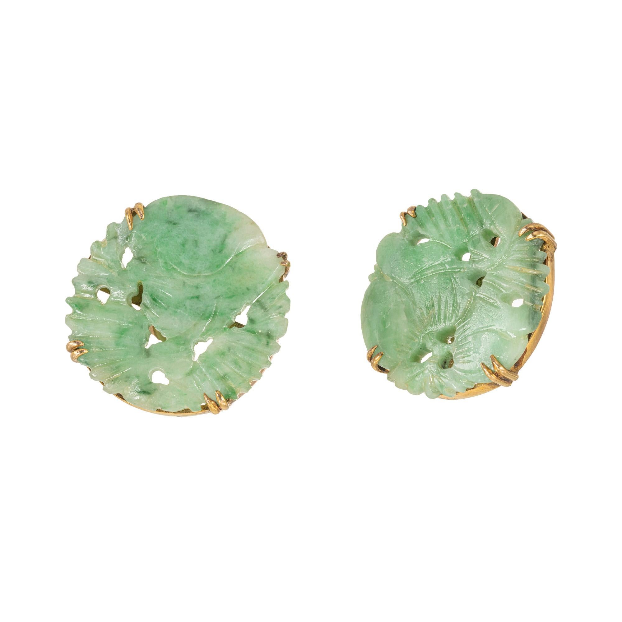 These 1960's AGL certified natural jadeite jade earrings is the perfect statement piece for any special event. The jade pieces are round tablets that are intricately carved and then set in 14k rose gold settings. The earrings feature double claw