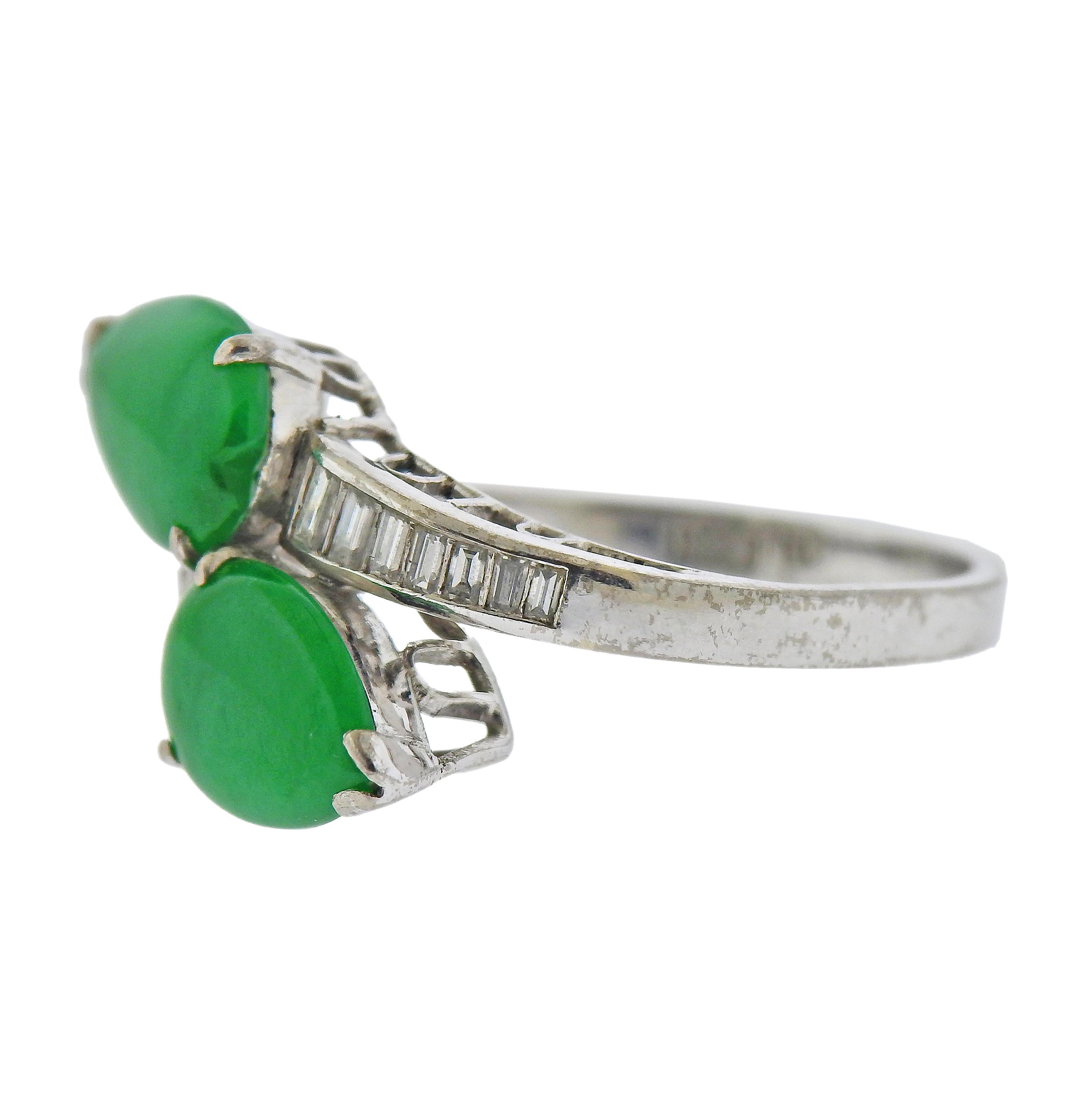 14k white gold bypass ring,  with two pear shaped natural jadeite jade gemstones, measuring 9.5 x 7mm and 7.4 x 6.95mm, surrounded with approx. 0.12ctw in diamonds. Ring size - 7, ring top - 15mm wide. Marked: 14k. Weight - 4.2 grams. 