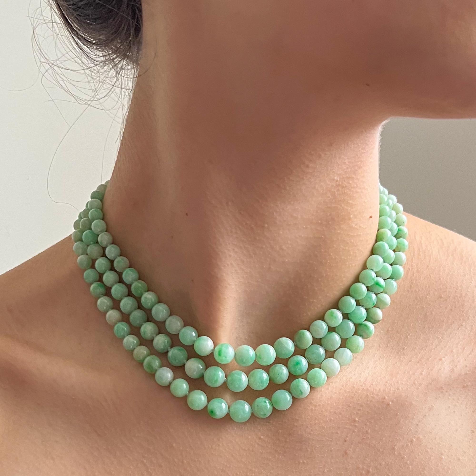 This apple green jadeite jade multi-strand necklace is from the early 20th century. The necklace consists of 154 jadeite jade stones, every piece of jade on this necklace is mottled in green and white. The jade strands are strung with these