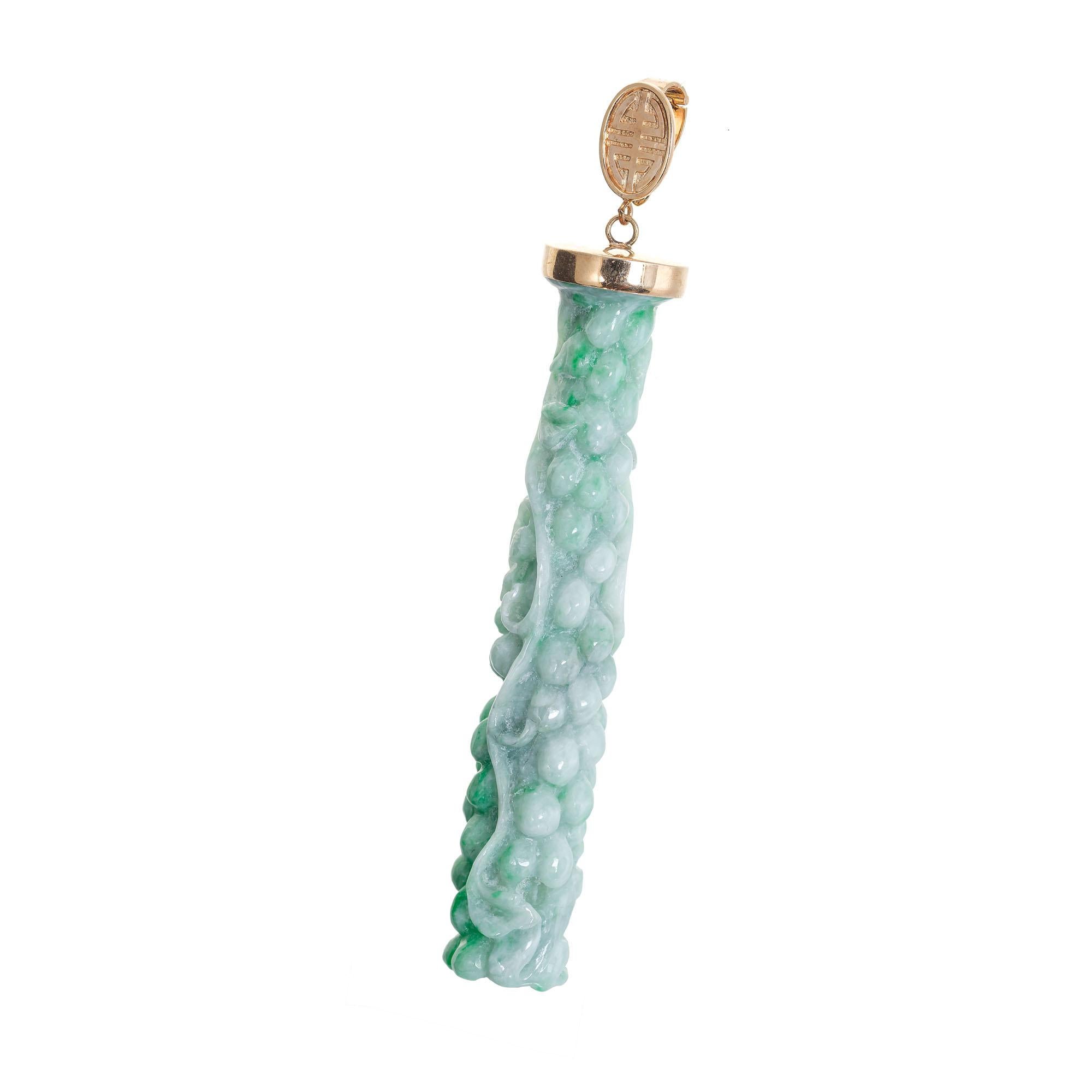 Natural untreated carved variegated Jadeite Jade pendant with a 14k rose gold top with a hinged pendant enhancer loop. 

Natural Jadeite Jade variegated green tapered carving 73 x 13 x 13mm.   GIA certified #5131341597 natural color no