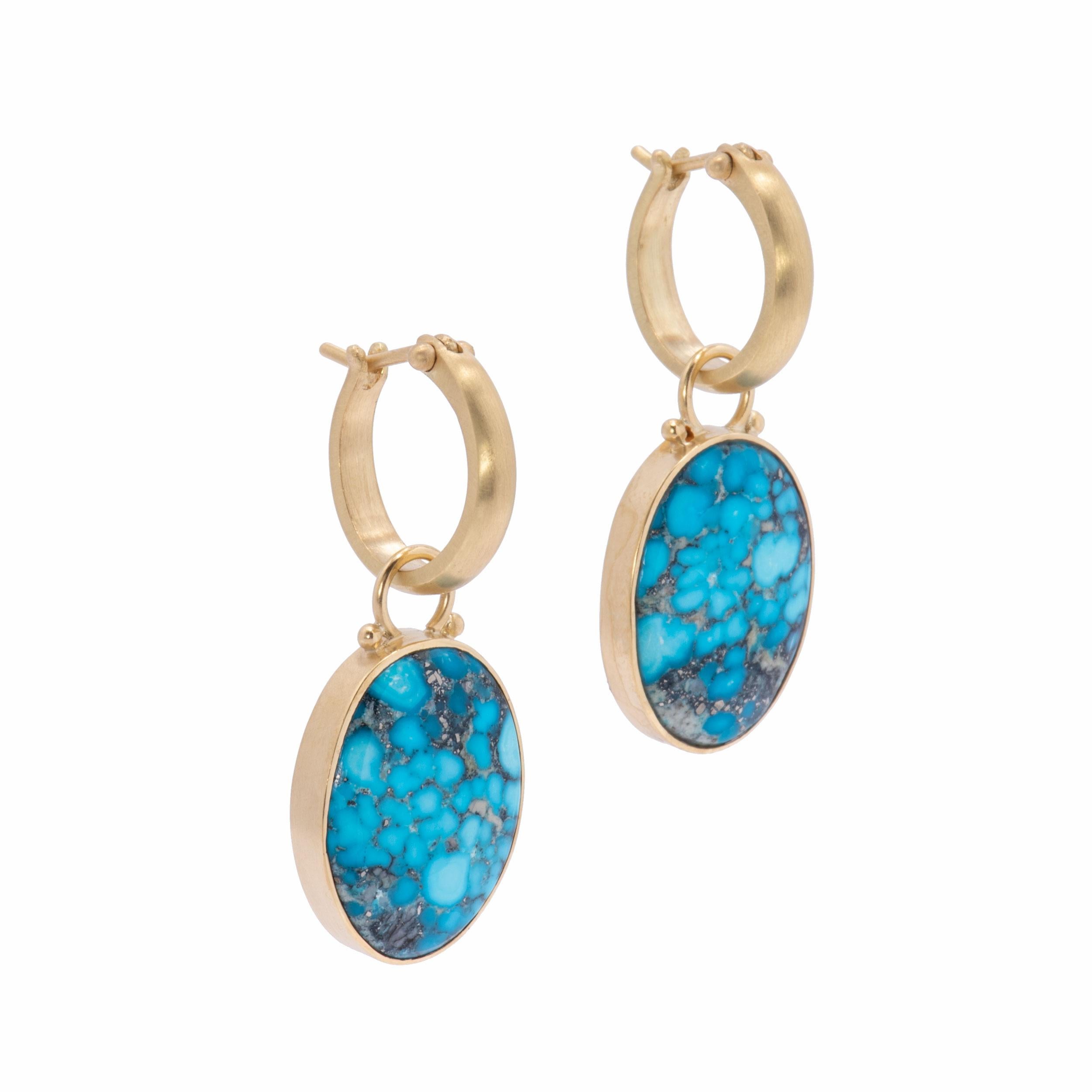 Natural Blue Kingman Turquoise Oval Drop Earrings are bezel set in 18k gold and backed with smoky, glowing mother of pearl. The simple drama of large Kingman Turquoise 30ctw. is alive with a strong matrix of black and silver and is framed in 18k
