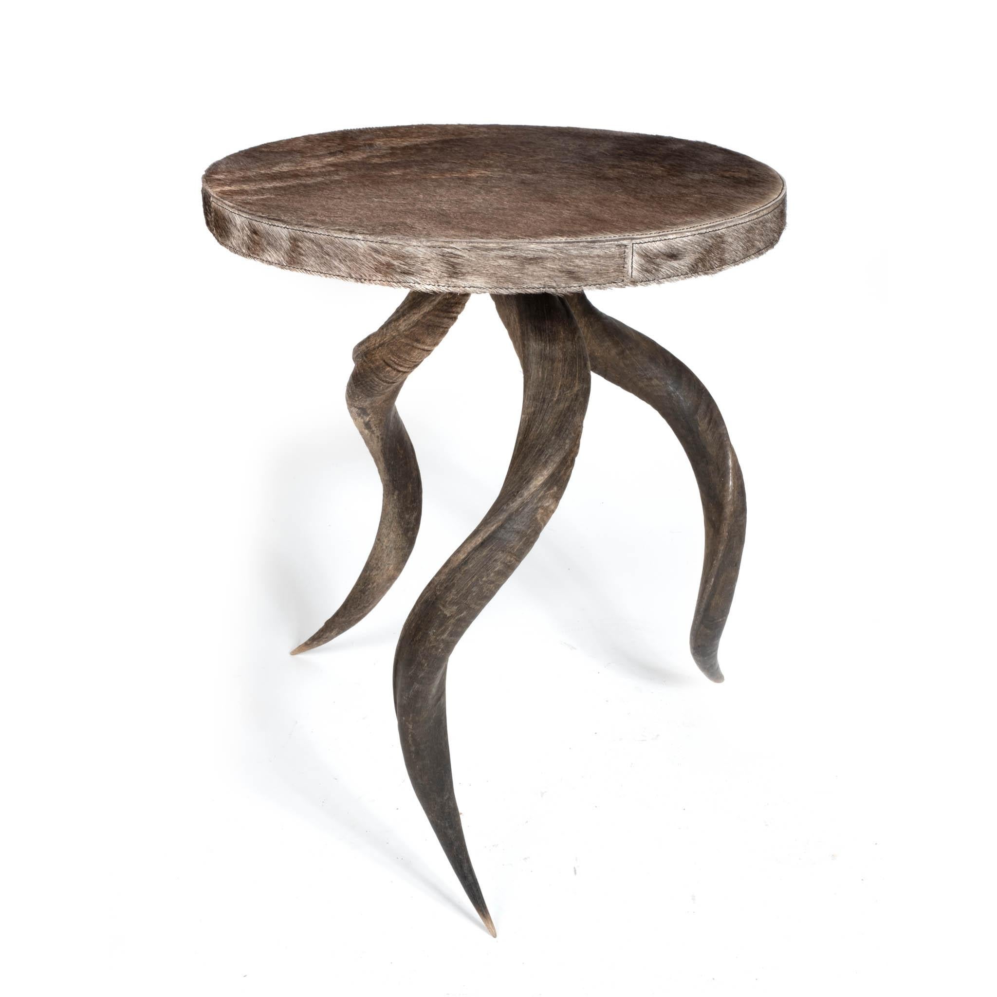 A naturally luxurious addition to any room, this side table is set on a trio of sustainably sourced, natural kudu horns with authentic wildebeest hide top. Due to the use of natural materials, each piece is unique and may vary slightly from image