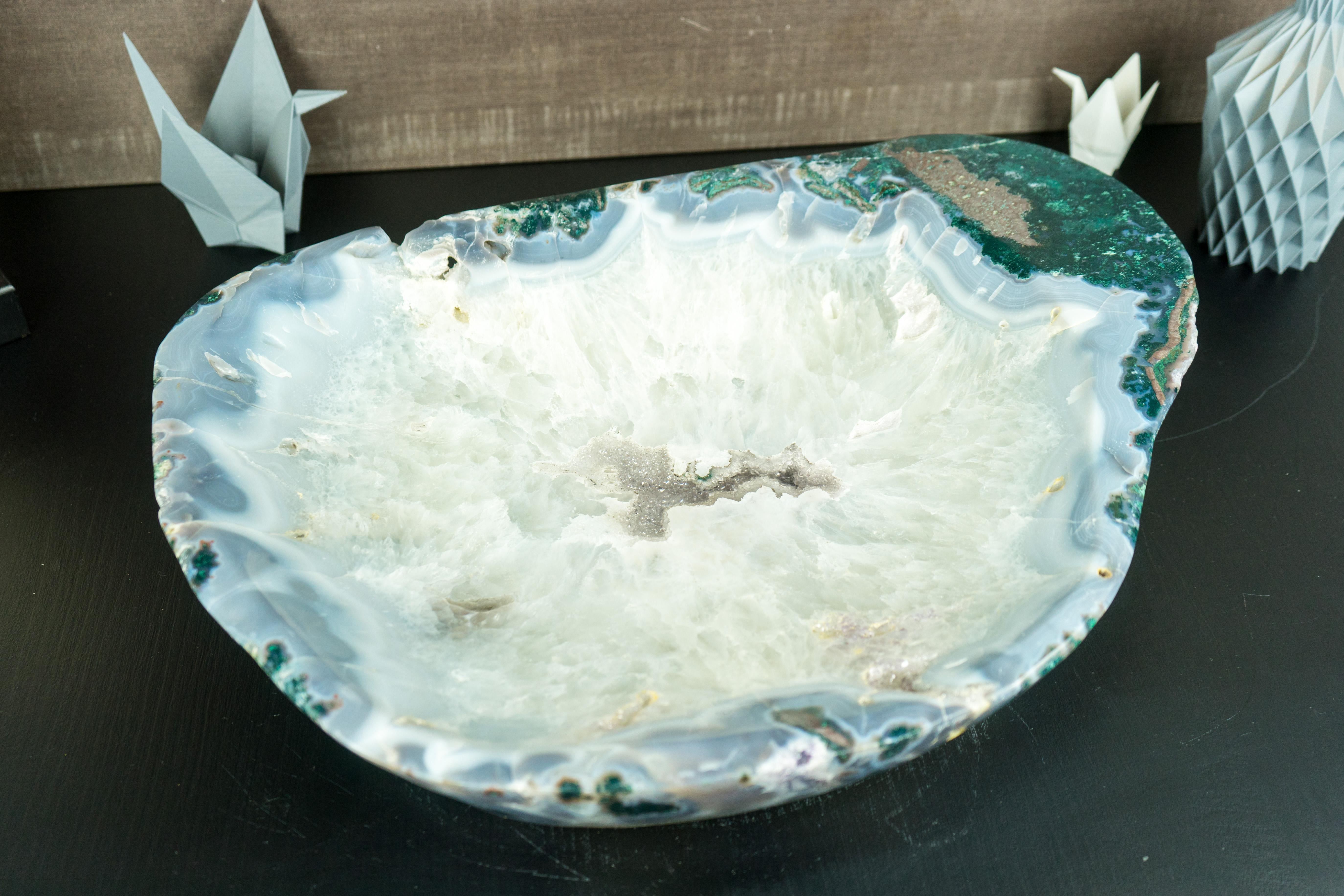 Hand-carved from a unique X-Large Lace Agate Stone, this bowl will be a perfect upgrade to your home or workspace decor. Whether used as a place to display crystals, a decorative piece, a crystal fruit bowl, or a focal point on your desk, it offers