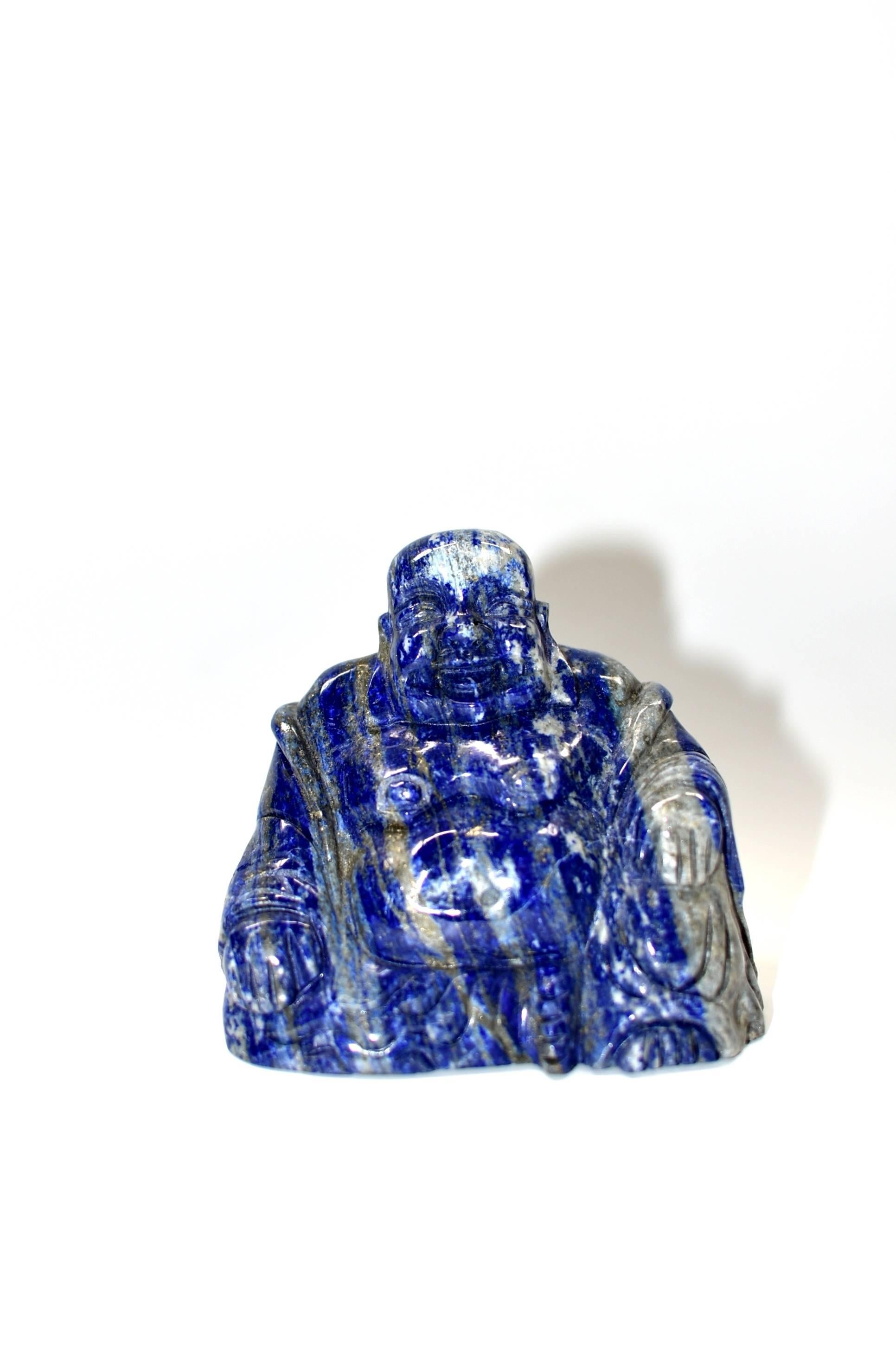 All natural Lapis happy Buddha, hand-carved. Besides the brilliant, saturated, signature blue, this piece has beautiful glittering of gold. The great contrast of the gold against the saturated blue has a stunning visual effect. Happy Buddha is a