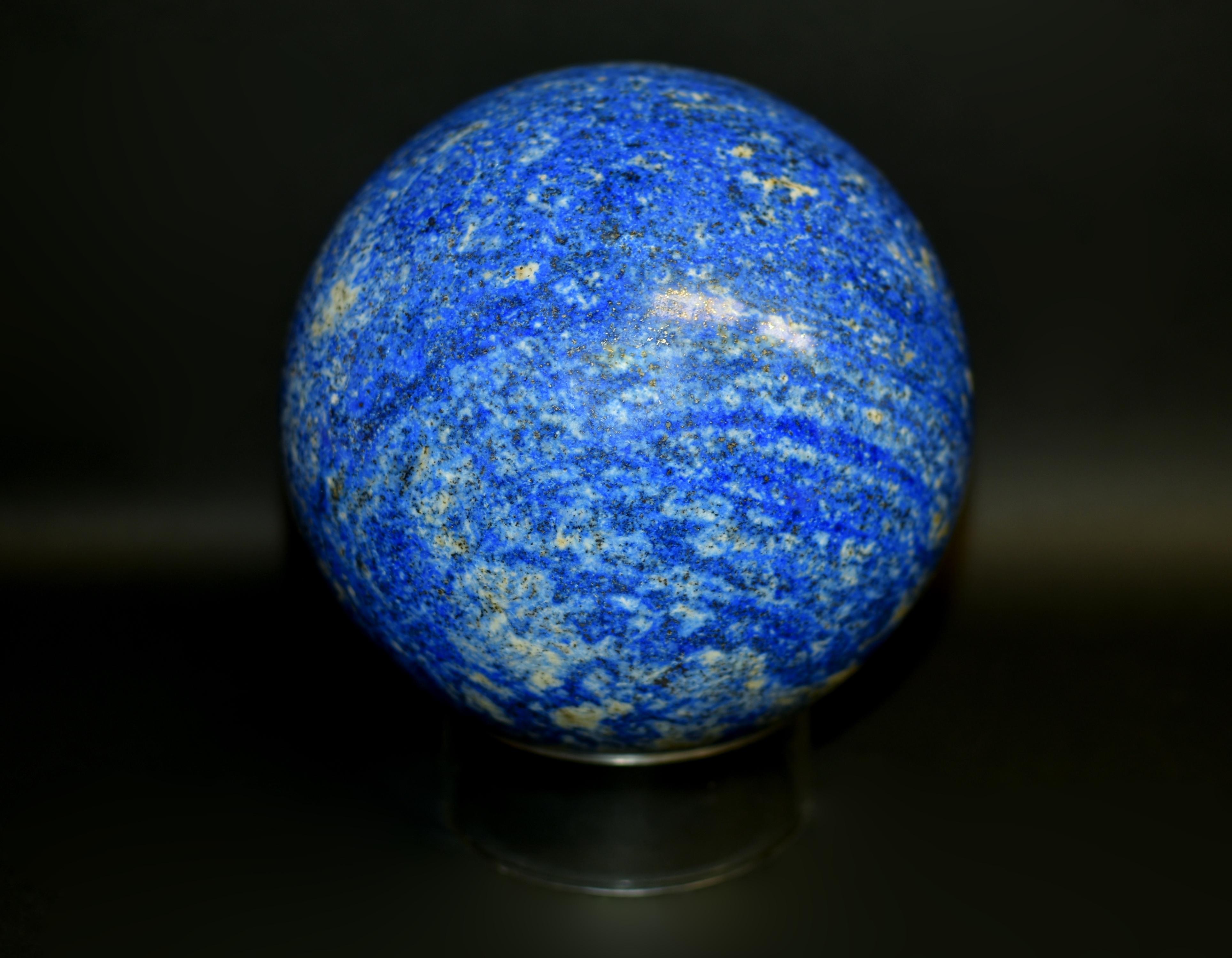 An extraordinary sphere of natural lapis lazuli, exceptionally large and heavy with spectacular images of the galaxy. The globe cut from a substantial boulder of lapis from Afghanistan, finely polished to achieve striated effect, swirls, scattered