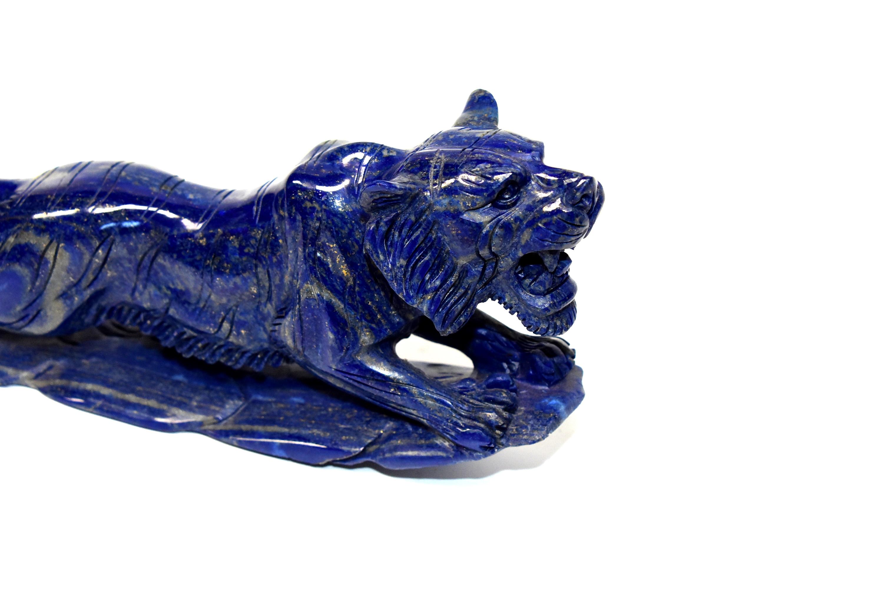 A beautiful all natural lapis lazuli tiger sculpture. The 2 lb stone's blue is bright and saturated with a violet hue, and beautiful glittering of gold. The great contrast of gold against the magnificent blue has a stunning visual effect. The beauty