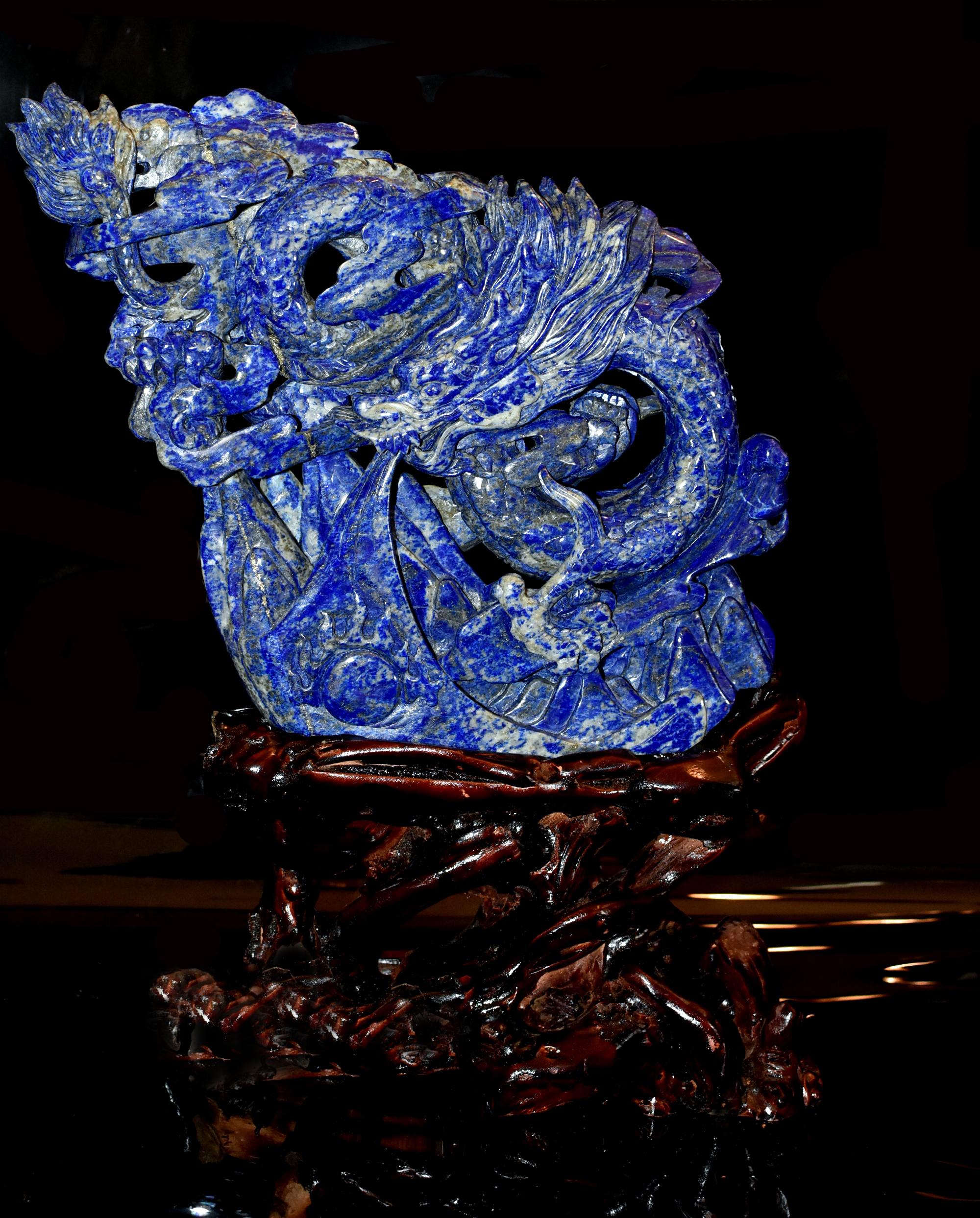 A beautiful, substantial statue of Lapis Lazuli, hand carved by a master artisan on both sides. The sculpture depicts a dragon flying in the clouds above mountains while spraying water onto earth, a sign of drought relief. Masterful depiction of