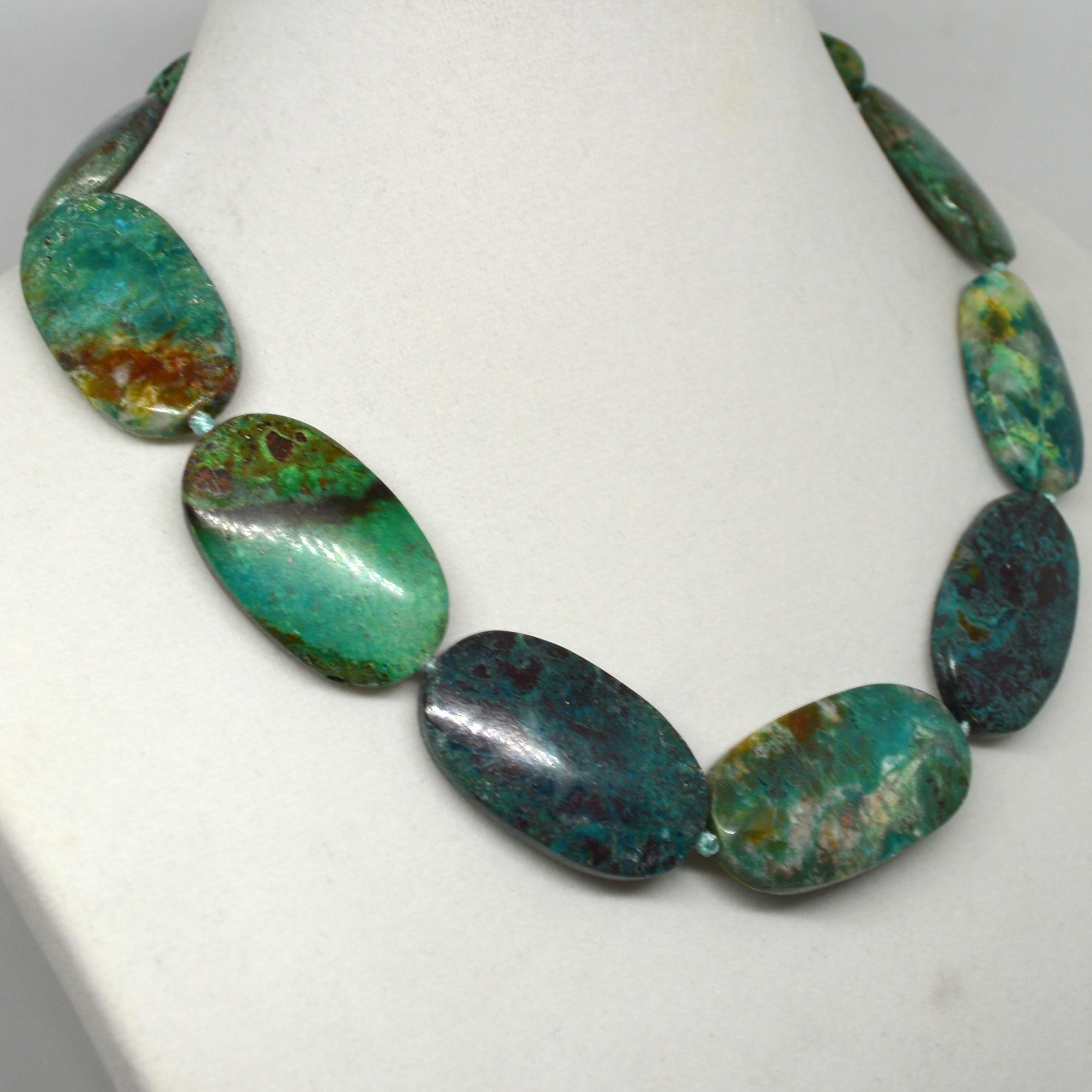 Large flat oval Chrysocolla beads ranging in size from 37x22.8 to 44.4x22.6mm for the longest bead finished with an elegant 55mm Sterling Silver hook clasp.
Finished necklace measures 46cm